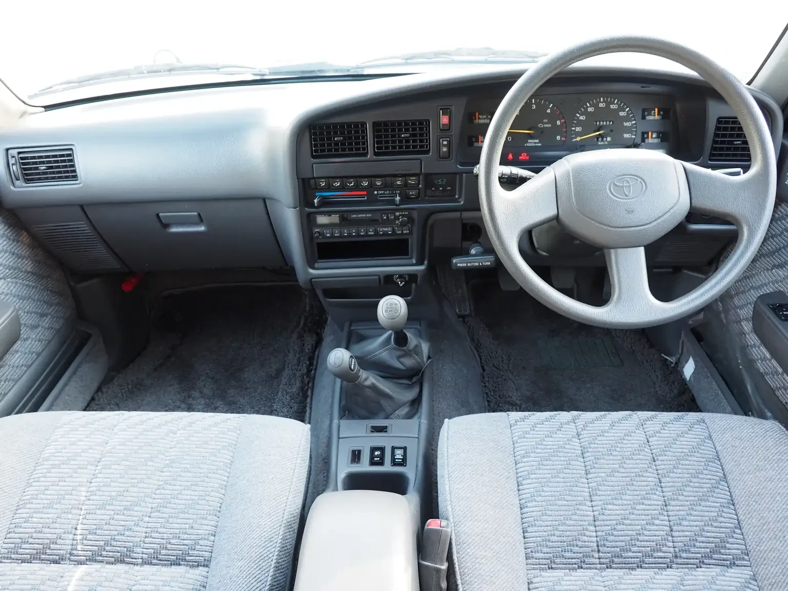 front dash and seat interior view grey toyota hilux surf kzn130 1kzte 5 speed manual diesel turbo JDM export vehicle Japan