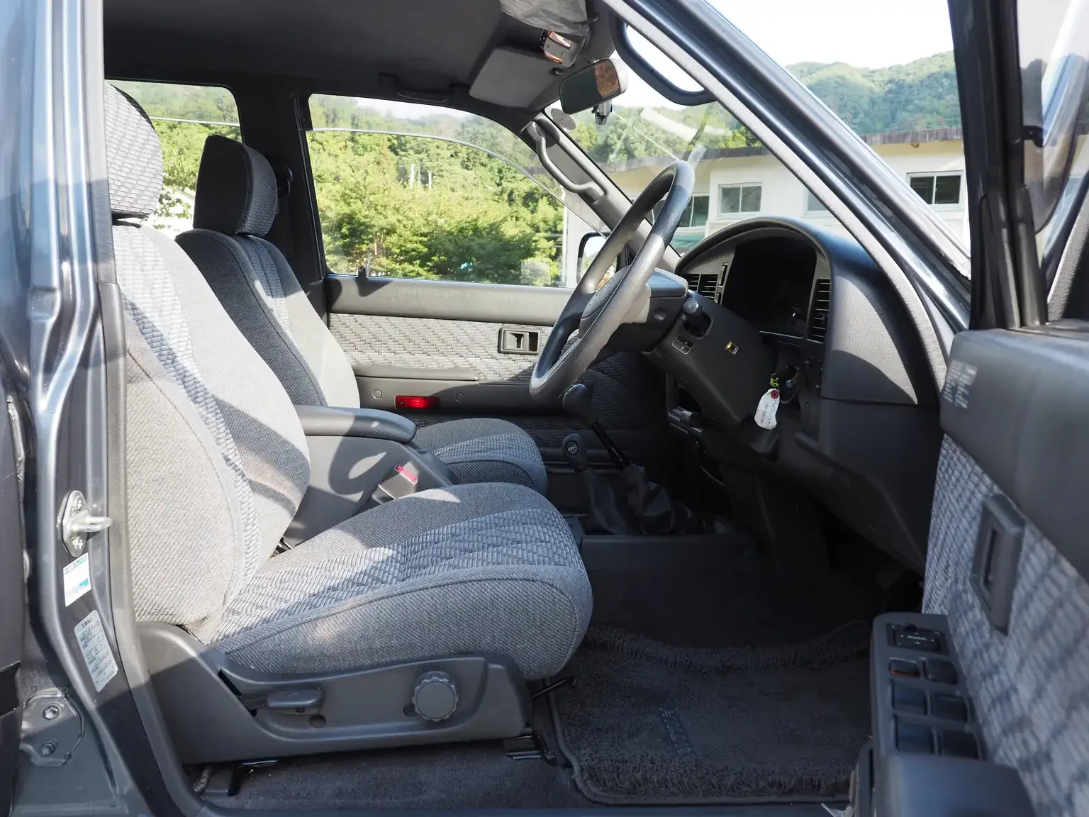 front interior view drivers seat view grey toyota hilux surf kzn130 1kzte 5 speed manual diesel turbo JDM export vehicle Japan