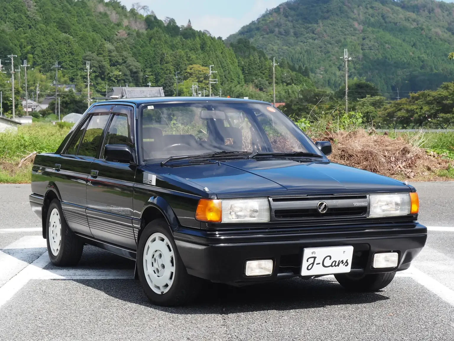 front view of 1989 Nissan sunny super saloon twin cam NISMO in black jdm export vehicle Japan