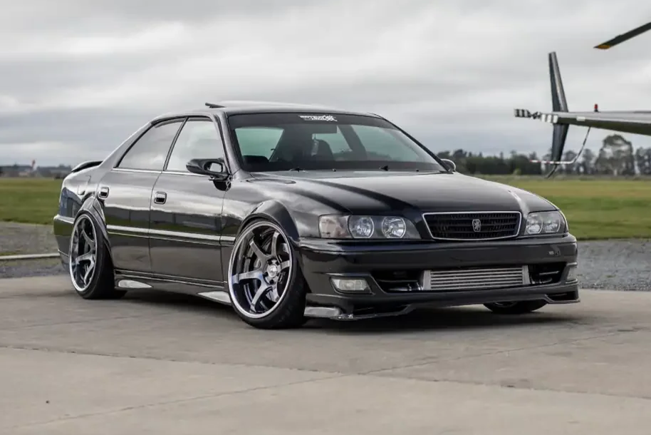 front angle view full custom wide body black toyota chaser tourer v jzx100 jdm export vehicle for sale New Zealand