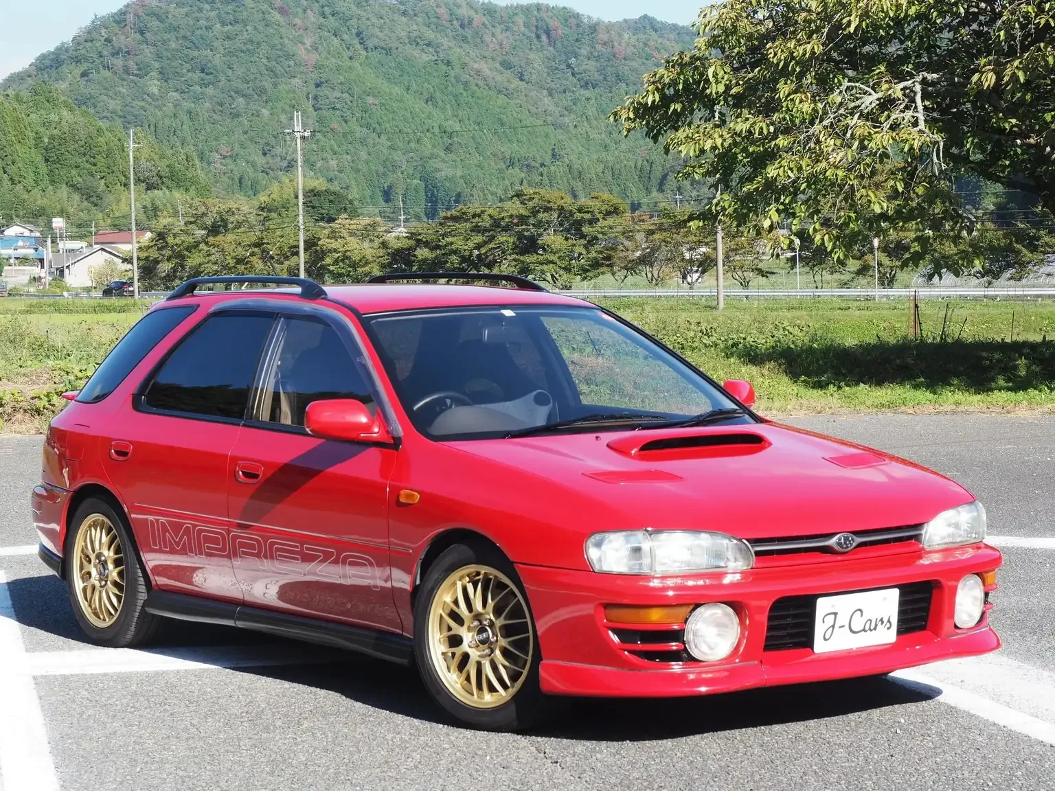 front driver side angle view 1996 subaru impreza wrx wagon red jdm classic car export from Japan