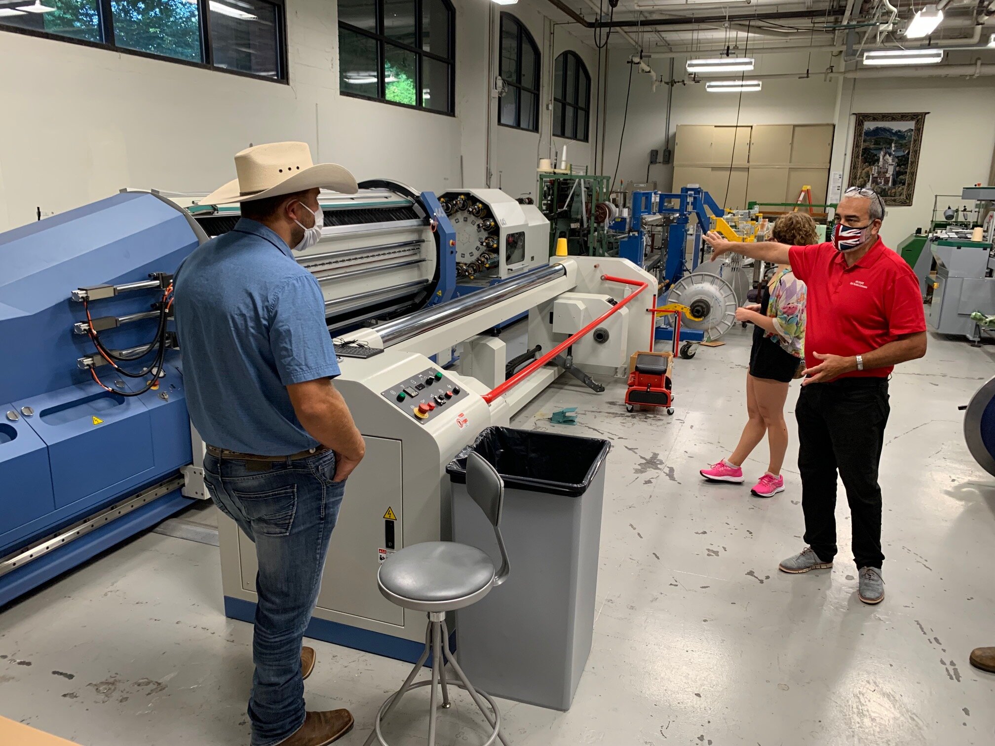 Montana Department of Agriculture marketing representative Weston Merrill listens as Dr. Andre West, director of the Zeiss Textiles Extension Center explains the equipment and process for spinning cotton and how hemp must look and perform to work in these processes.