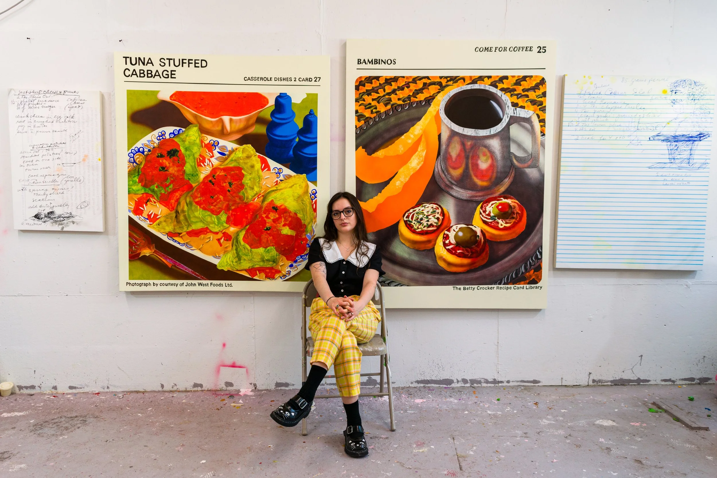 Abbi Kenny in her studio in front of four paintings.