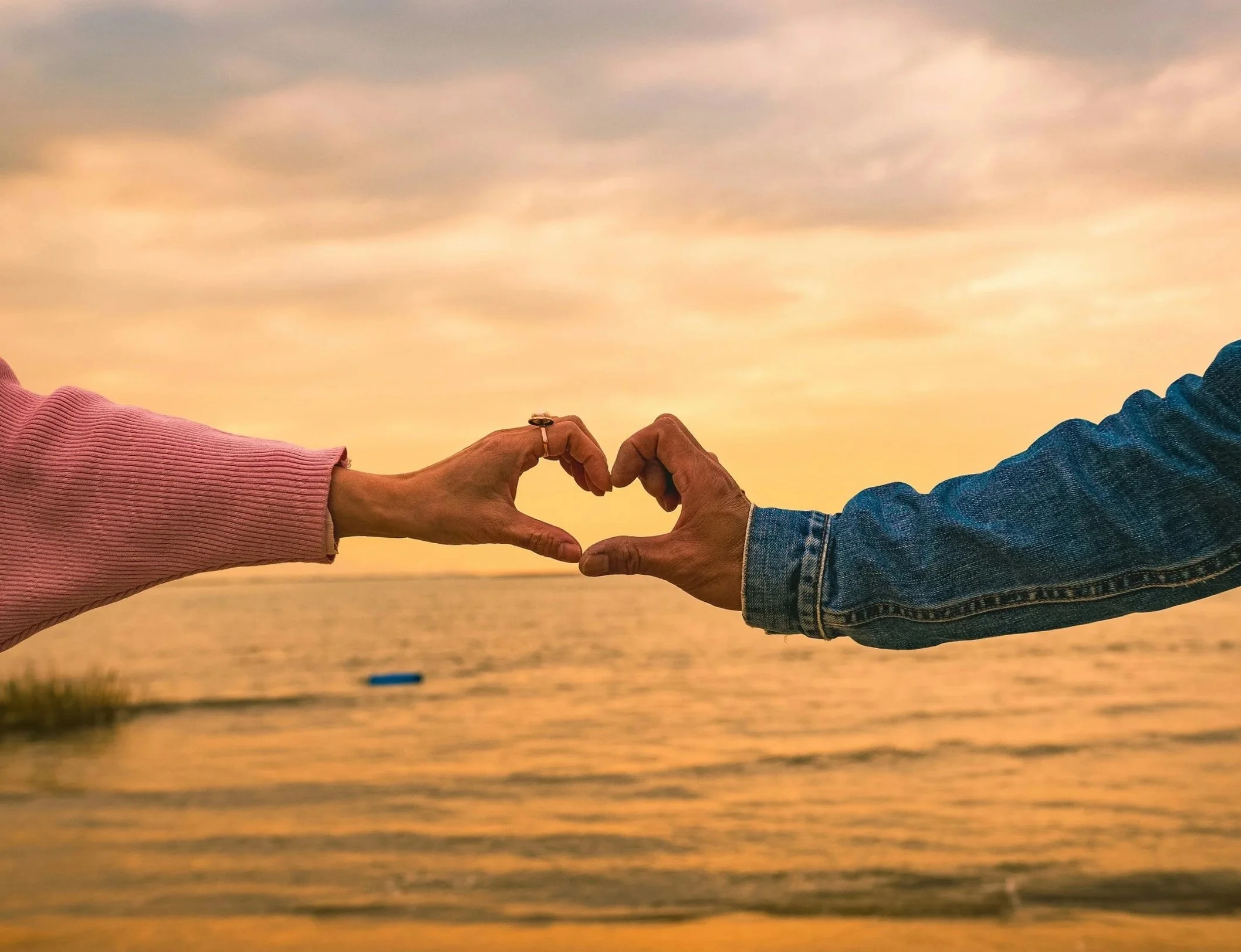 Two hands forming a heart shape representing emotional connection and secure relationships through Emotionally Focused Therapy at Lotus Soul Therapy.