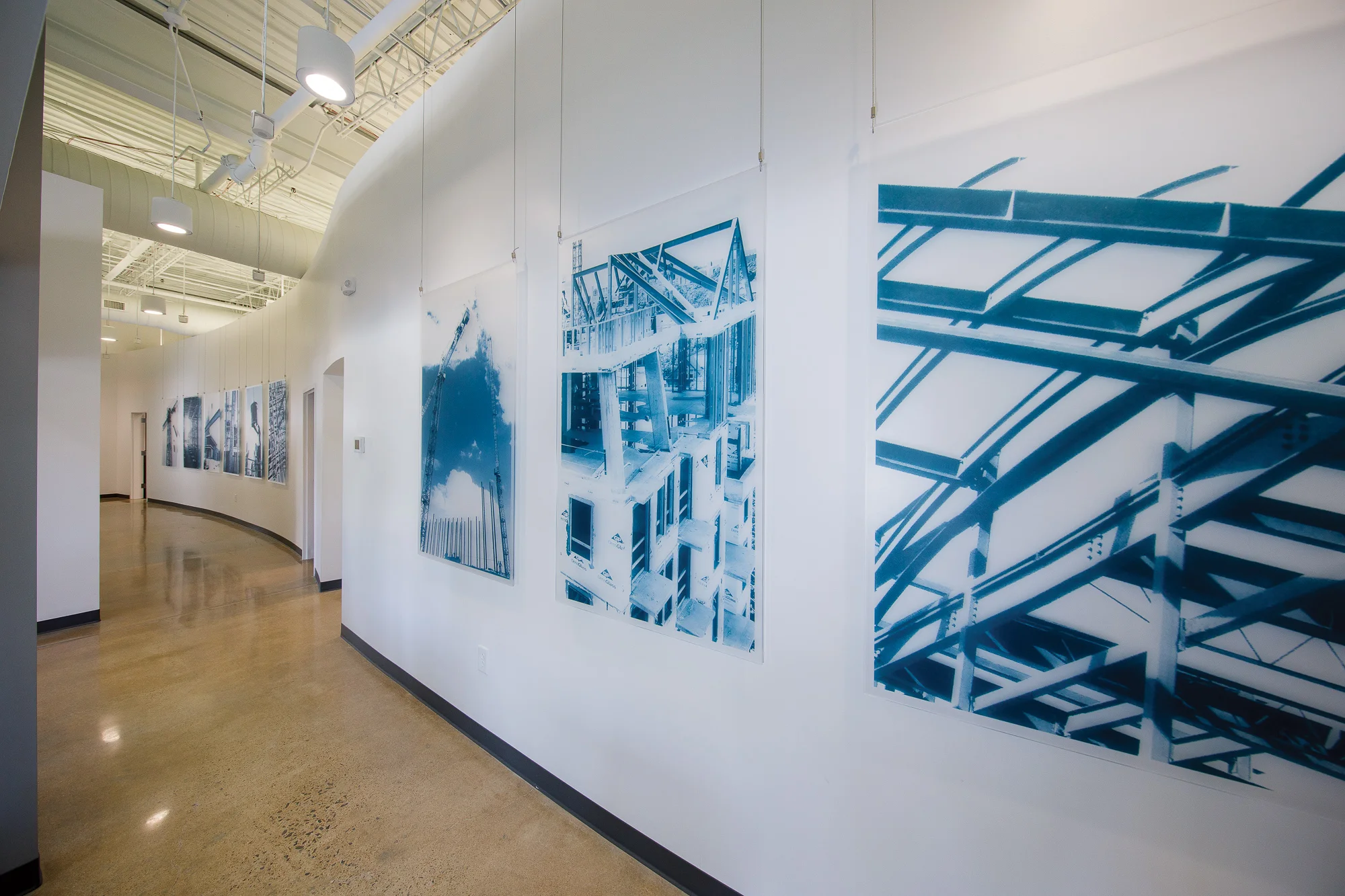 Large format project graphics printed on acrylic and suspended from overhead framework