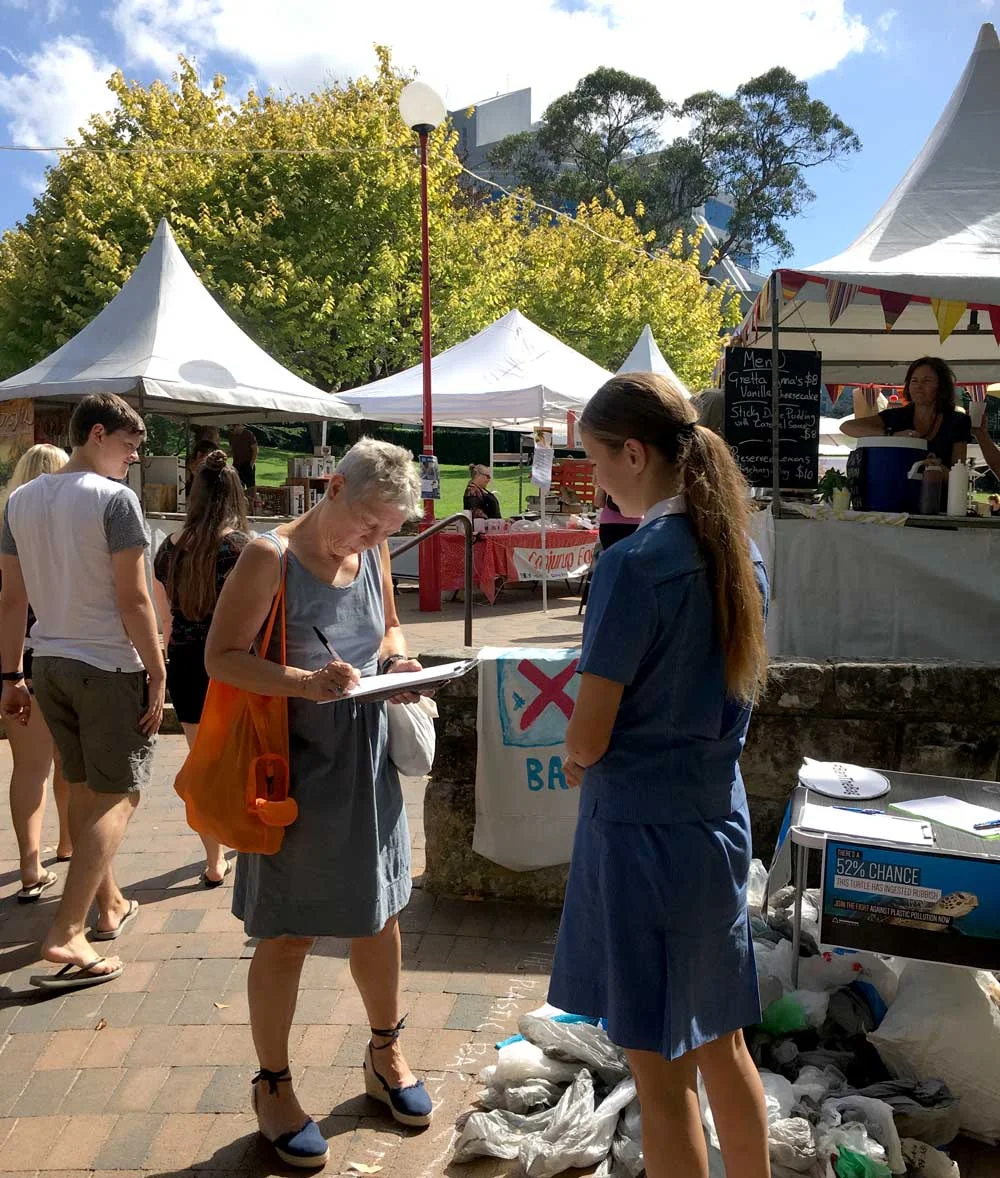 Collecting more signatures at Northside Produce Markets in April