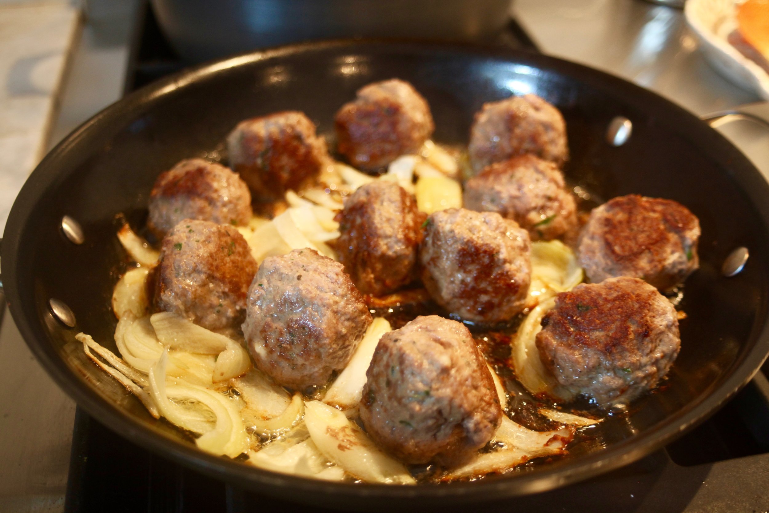 Meatballs and onion cooking up