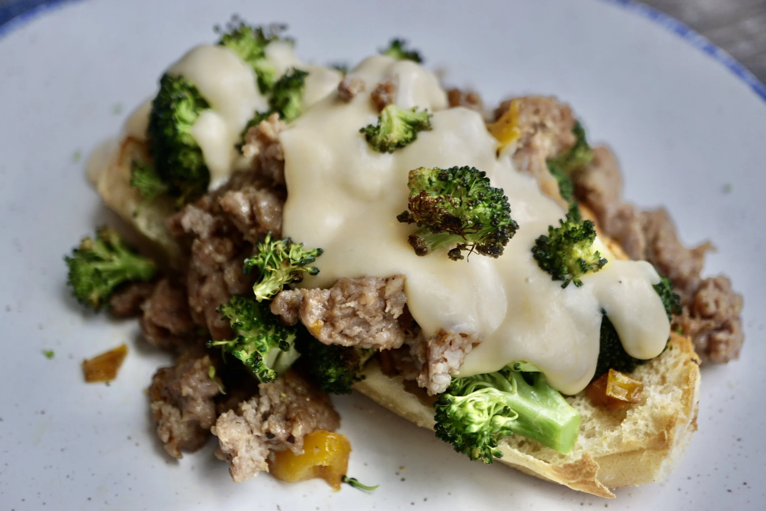 Open Face Sausage and Crispy Broccoli Sandwich with Cheese Sauce