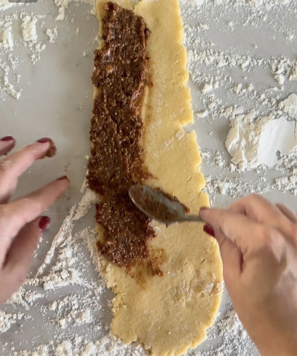 Roll out the dough into a long rectable and fill one side with the fig mixture