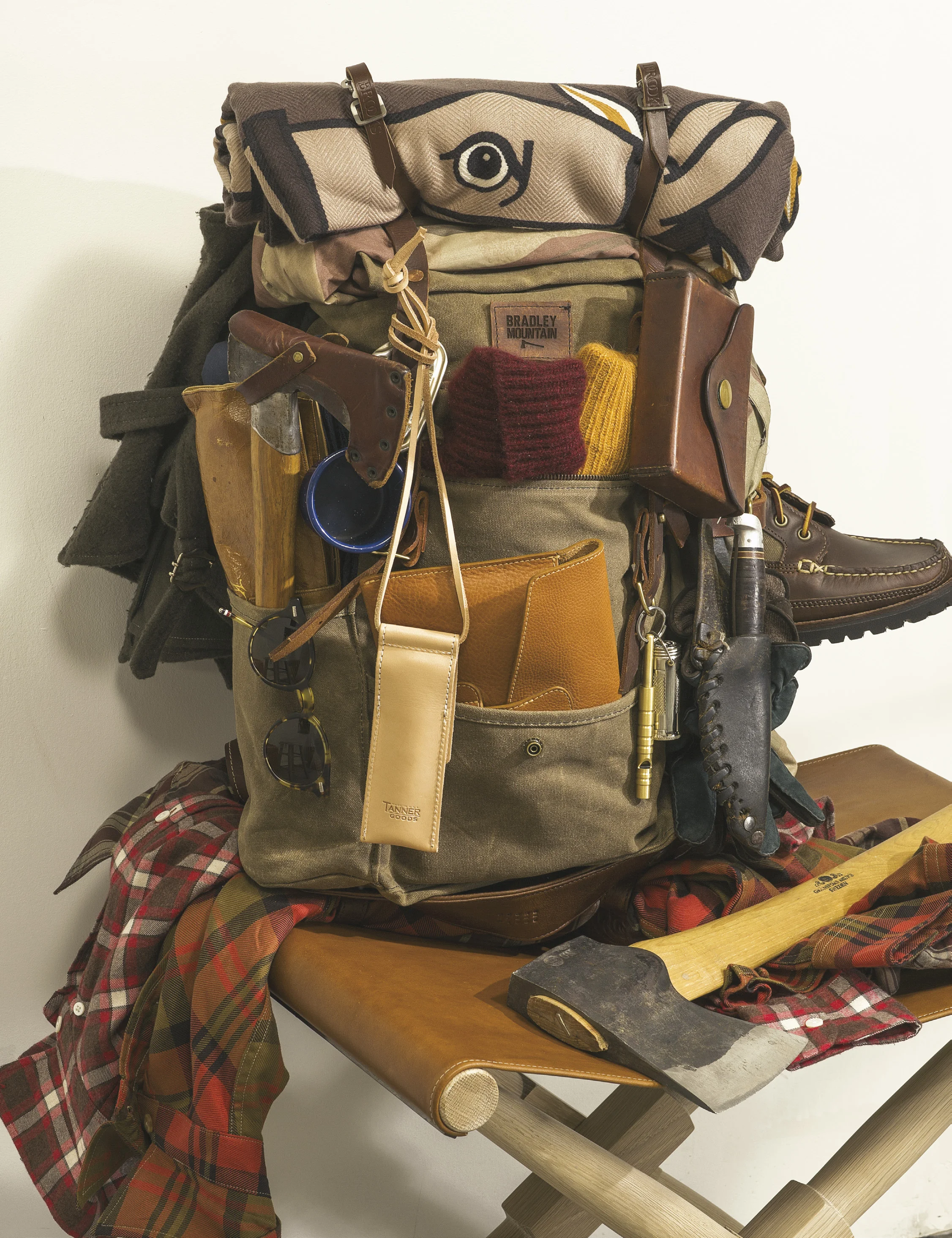 clockwise from top left: handmade backpack BRADLEY MOUNTAIN cashmere blanket HERMES leather twin straps BROOKS ENGLAND cotton ventile coat NIGEL CABOURN canvas and leather field boot OAK STREET BOOTMAKERS white oak and leather campaign stool GHURKA cotton plaid shirt BILLS KHAKIS cotton check shirt HAMILTON SHIRTS wildlife hatchet and american felling axe GRAND FOREST match safe BEST MADE brass metropolitan whistle EDC leather ipad case LOTUFF steel and bamboo chop sticks in leather case TANNER GOODS handmade japanese acetate sunglasses THOM BROWNE wool vest L.M.B. 911 kid-mohair cashmere fisherman’s rib hat DUNHILL knit mohair socks MARWOOD