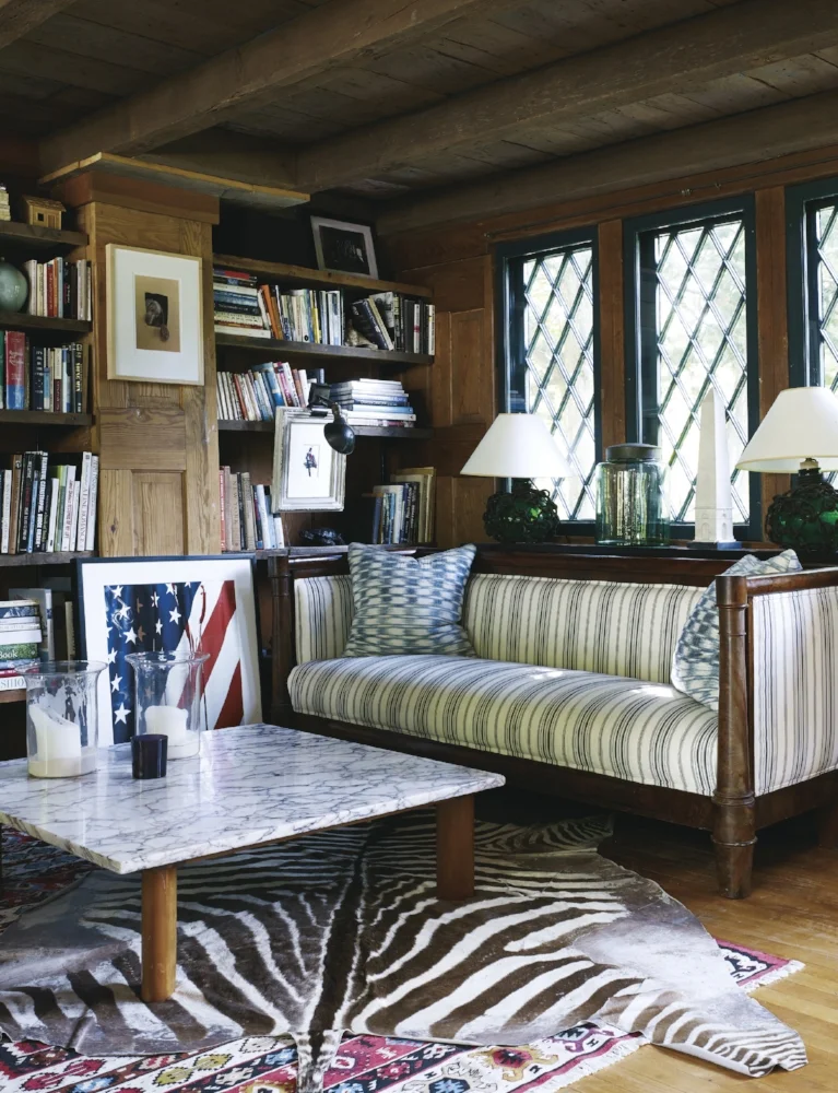 The living area in the main house looks out onto the pool. The diamond-paned windows were salvaged from a church, circa 1910.