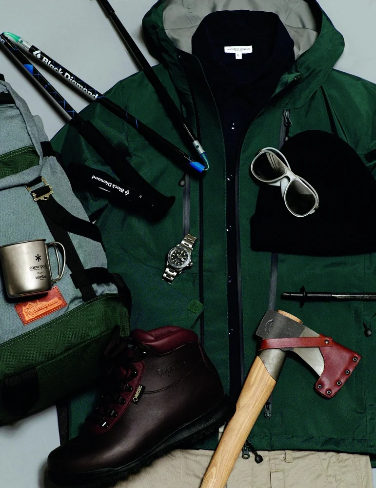 Wool and cashmere beanie OUR LEGACY, military shirt and fatigue pants ENGINEERED GARMENTS, rain jacket and titanium cup SNOW PEAK, socks WOOLPOWER, sundowner gtx hiking boots VASQUE 1315 glacier sunglasses VUARNET, rock pack forest axe GRÄNSFORS BURK, ultra distance trekking poles BLACK DIAMOND, gray submariner watch ROLEX available at manoftheworld.com