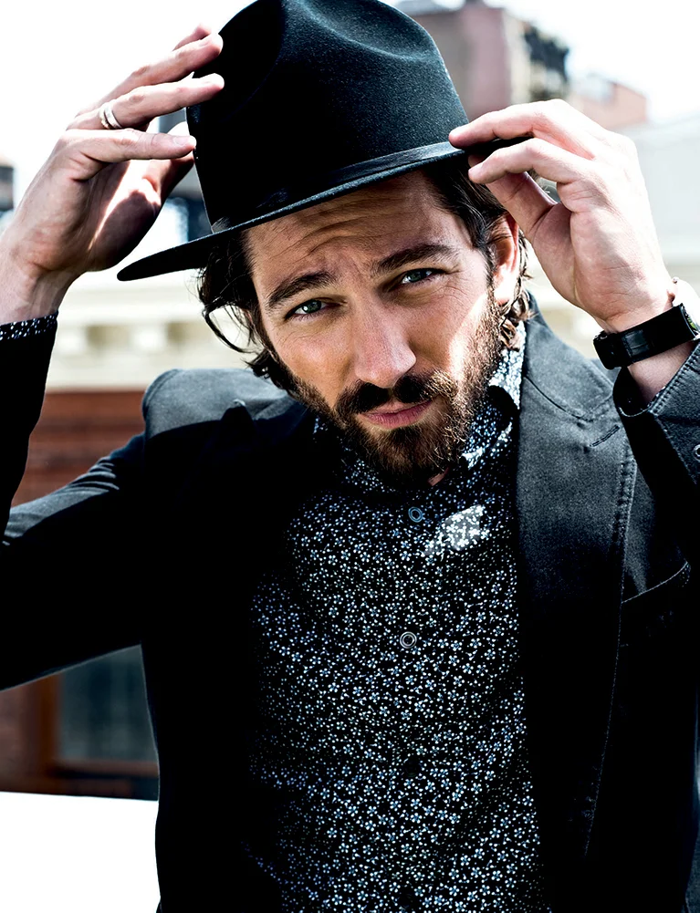 black buckley garment washed jacket, small flower-print slim fit shirt, and black nubuck grainy leather pants TOM FORD, mist calf shoe BOTTEGA VENETA, black wool baron hat BAILEY, duomètre à chronographe watch in rose gold JAEGER-LECOULTRE