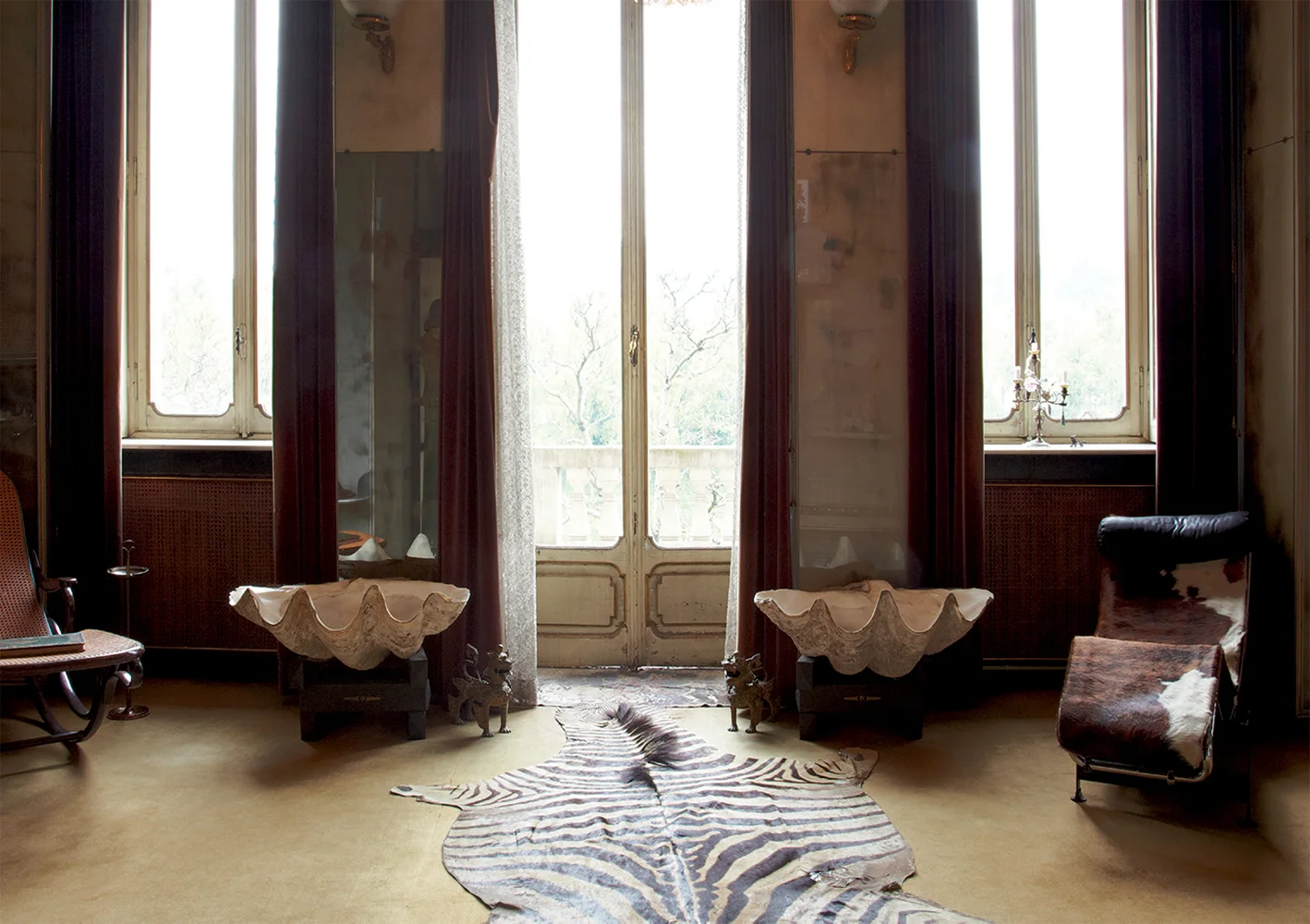 Midcentury architect and designer Carlo Mollino’s last apartment in Turin, Italy. In the central sitting area, a pair of giant clam shells and two chaise longues — a Thonet and a Corbusier, respectively — flank the door to the terrace. Miniature brass dogs serve as sentries.