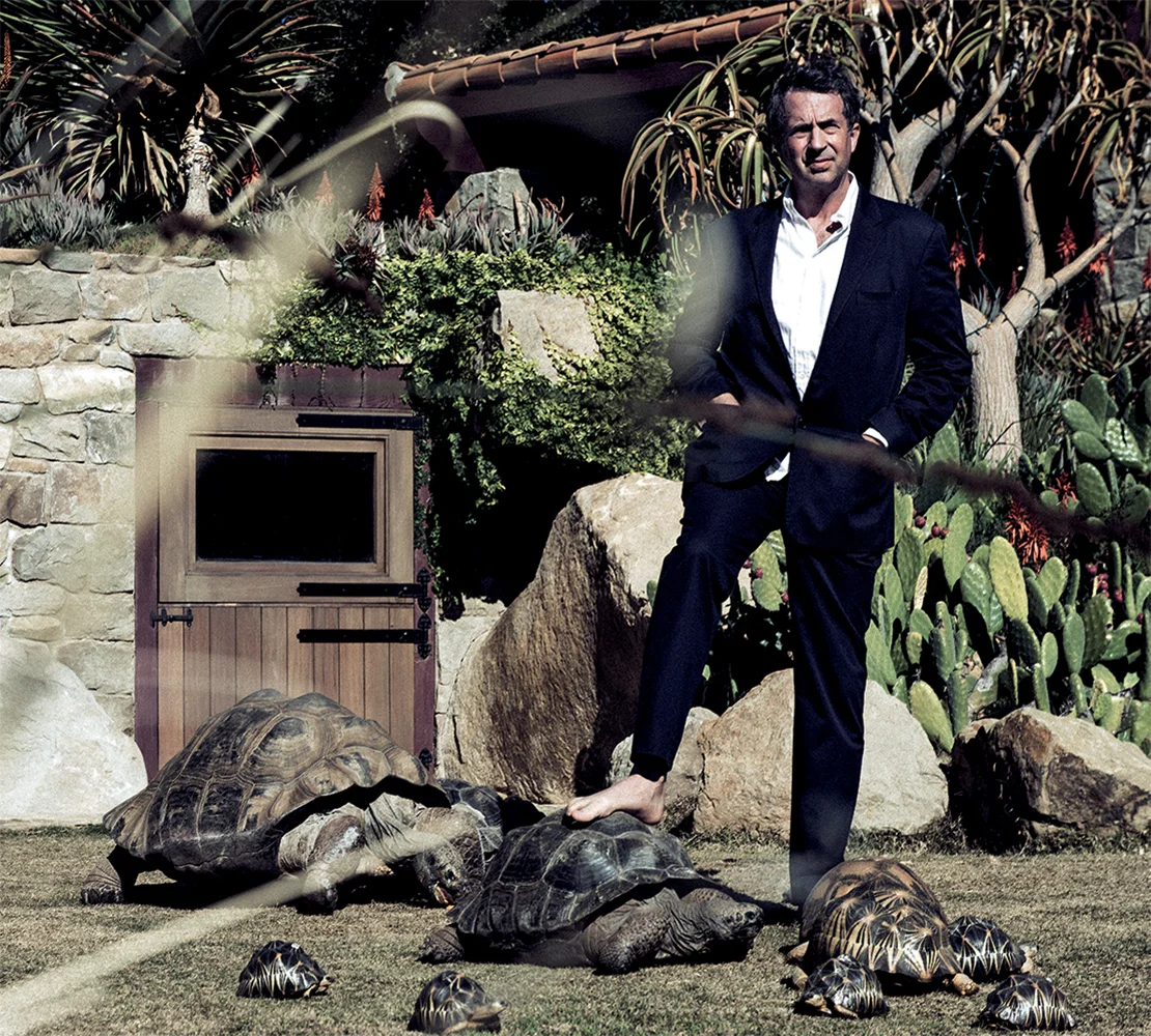 Goode consults his favorite Galapagos while surrounded by a cluster of radiata in one of several custom-built pens at the Behler Chelonian Center in Ojai, California. Suit HELMUT LANG, shirt ARMANI