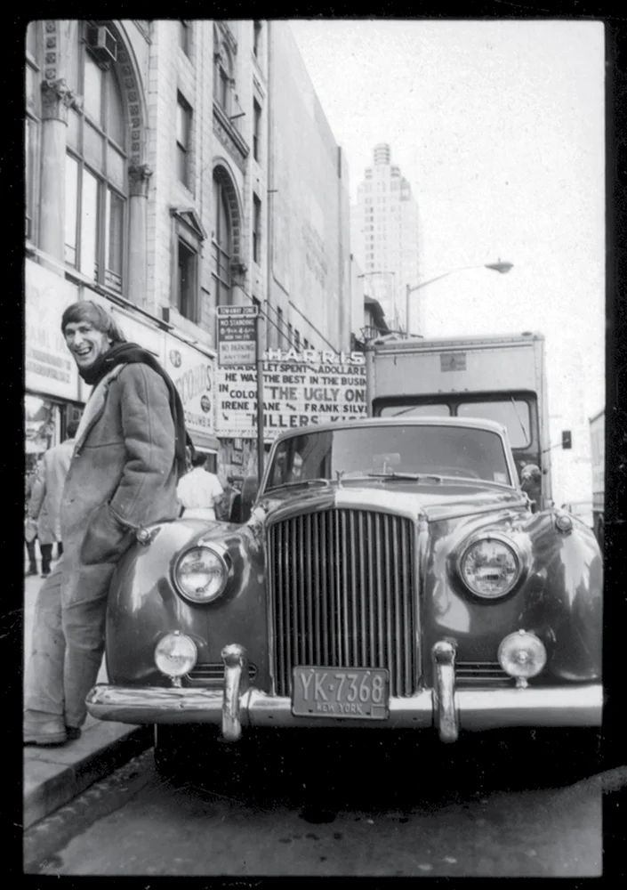 Posing with his Bentley in Times Square, New York City, 1960s. Photograph by Jay J. Good.