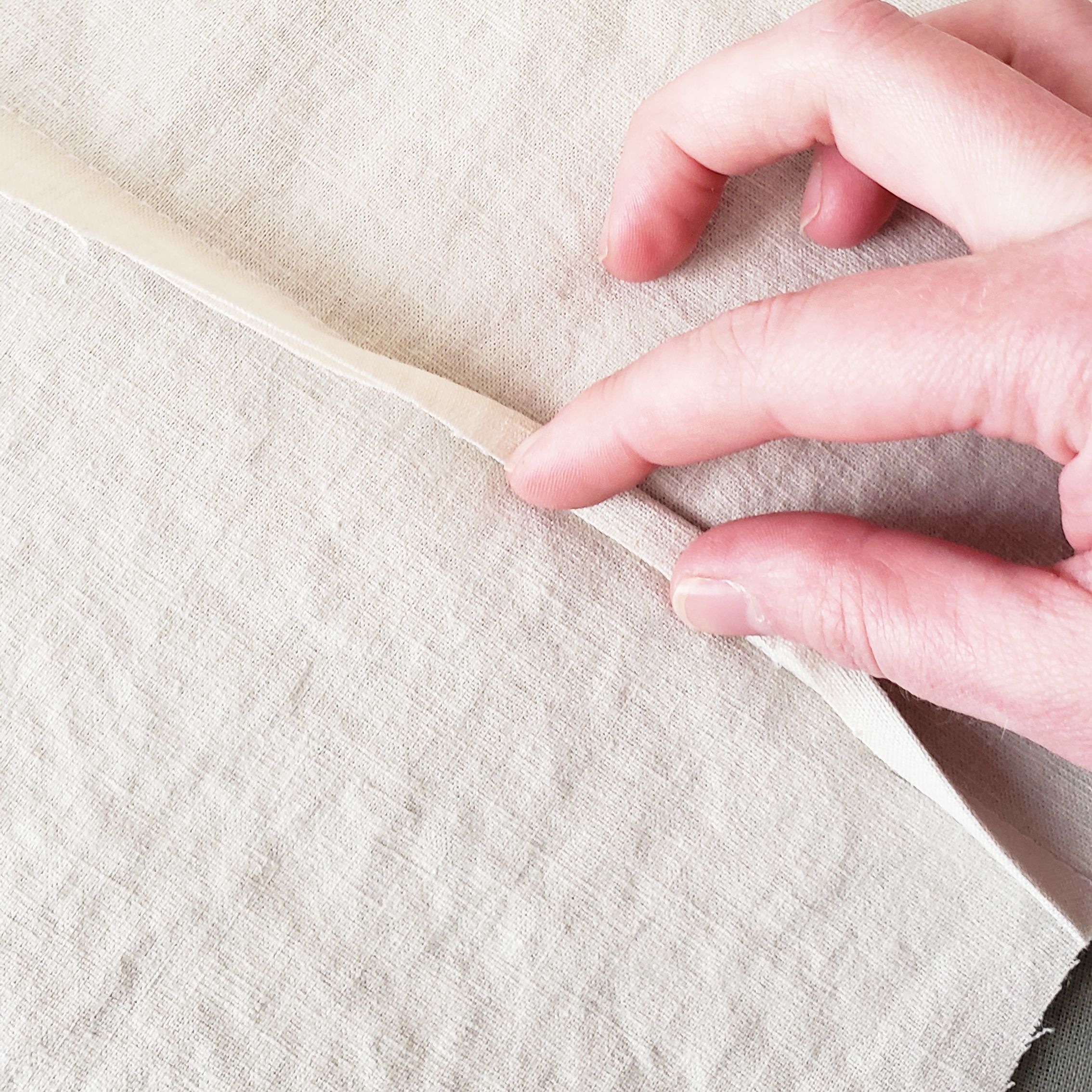 2. Fold the raw edge of the opposite side in half and over the edge you just trimmed