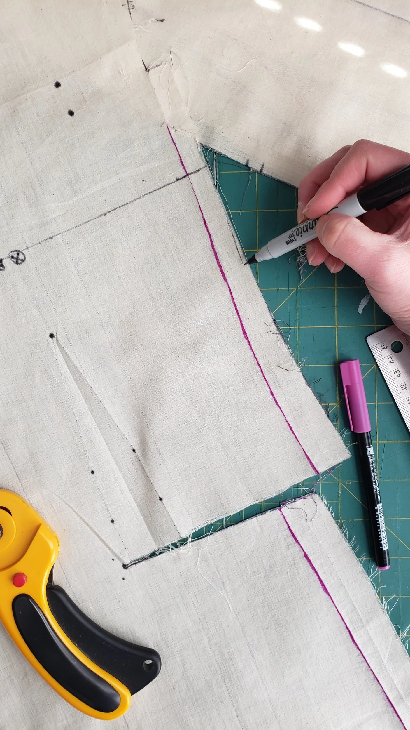 Marked new seams and adjustments on the muslin and trimmed the excess seam allowances