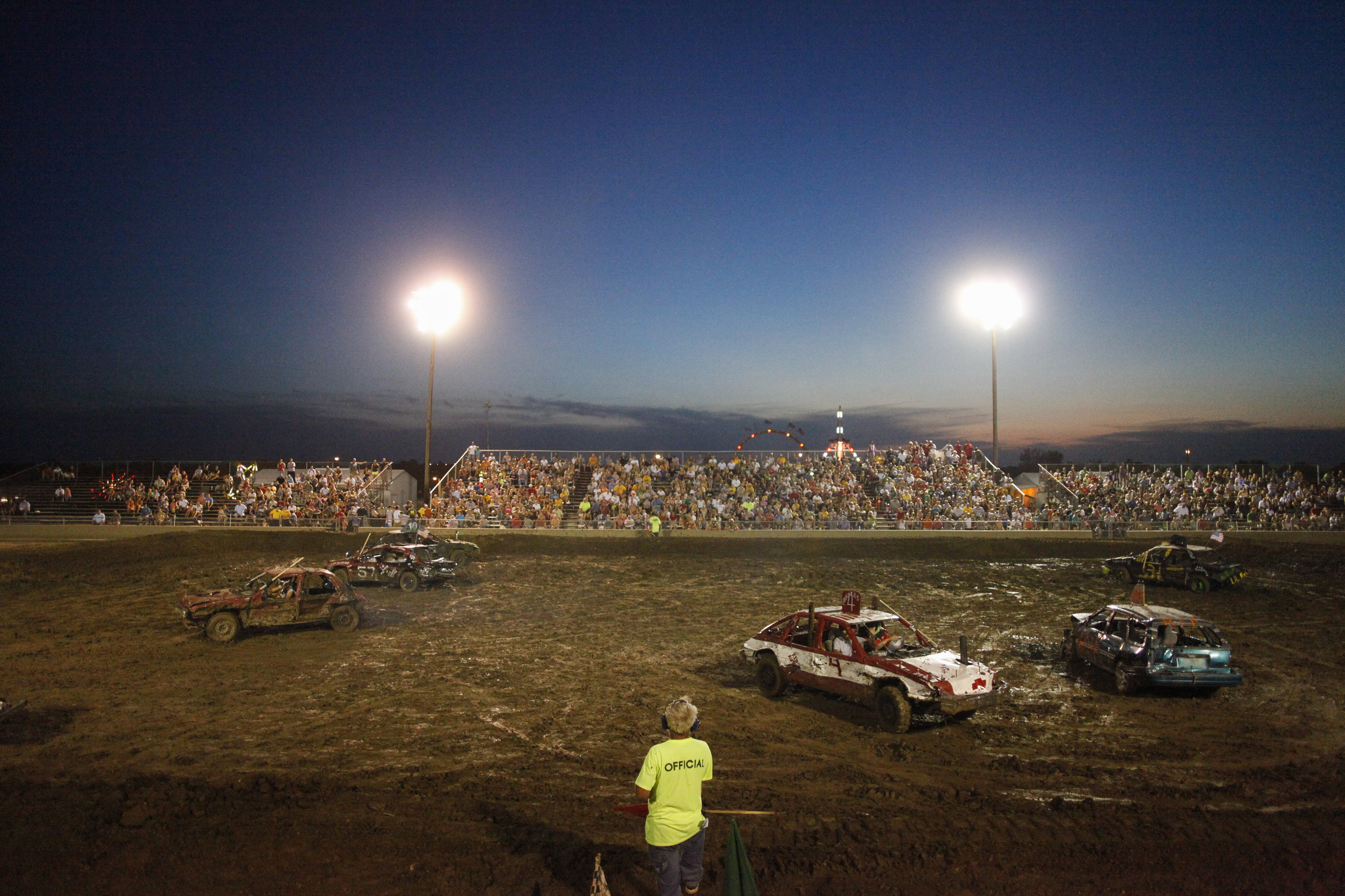   Demolition Derby participants wait to restart the race after a short break Wednesday evening, July 25, 2012 at Boone County Fairgrounds. 