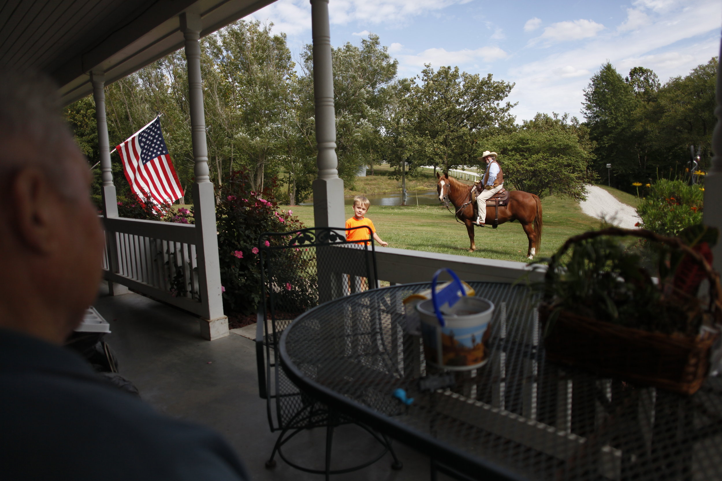  Rusty Savage, 51, center, talks to his friend, Carol Dell Buckler, 77 at Buckler’s front yard on Tuesday, Sept. 23, 2014 in Weston, Mo. Savage commented that Buckler bought that horse, Duke, for Savage to ride. Currently, Buckler’s property is on th