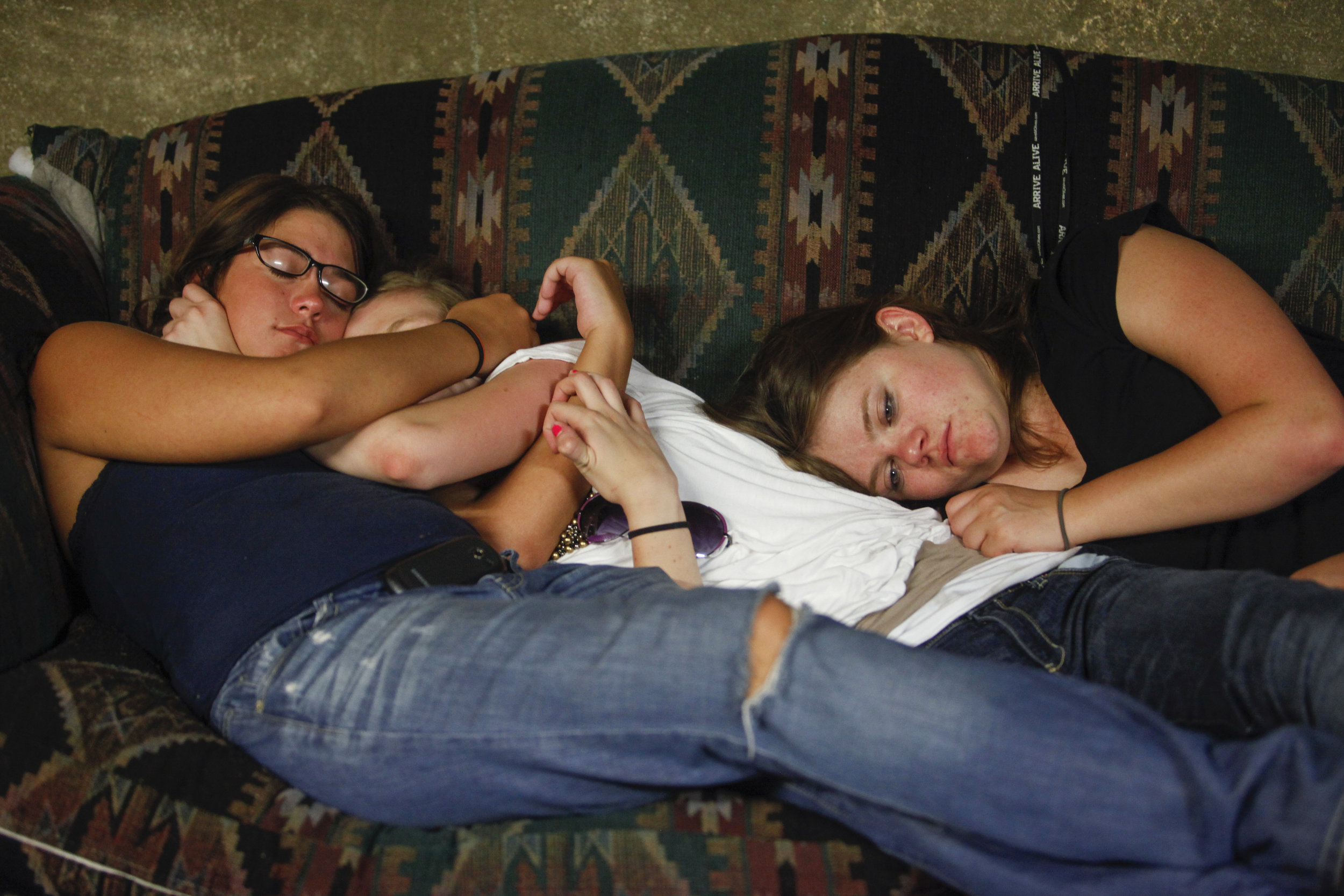  Cami Barnita, left, hugs Heather Hopkins as they are about to pass out after a party on the couch of their friend Sunday evening, May 6, 2012 in West Plains, Mo. Samantha Price lays with them and looks away. 