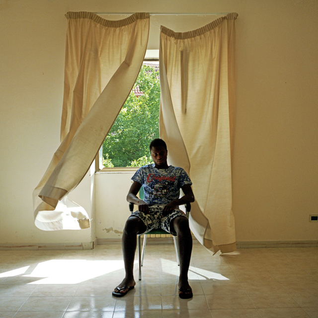 S. from Ivory Coast sits in the living room at the Aquino Zingale centre.