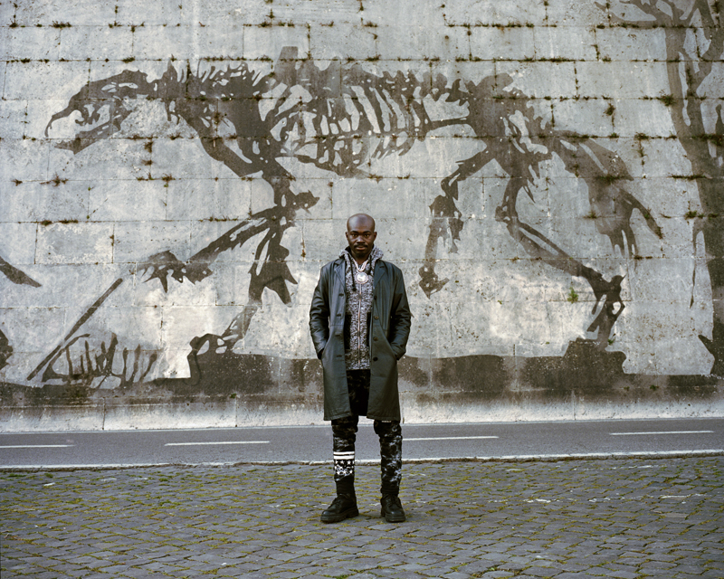 This portrait of Mohammad Ali taken on the banks of the Tiber River, Rome. I first met him in June 2015 when he was living in the C.A.R.A. di Mineo Reception Centre in Sicily. He had a very difficult time there and decided to leave and try his luck elsewhere in Italy. Originally from Sierra Leone, he was separated from his family as a child and he experienced significant physical abuse during the civil war. He still suffers extreme pain from the consequences of his injuries and does not have any contact with his family.