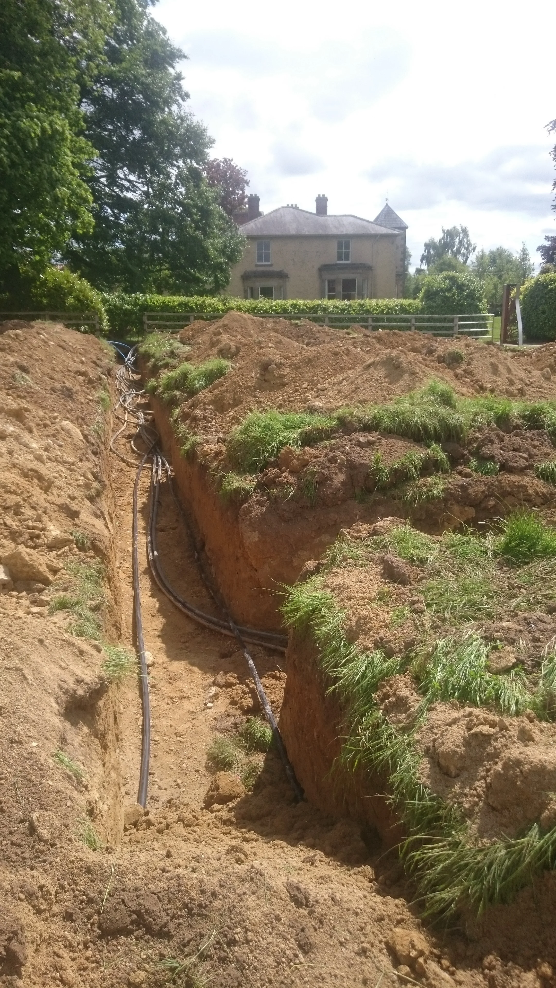 Excavations for 1.5km of ground loops for a new heat pump that replaces three oil fuelled boilers in a large house