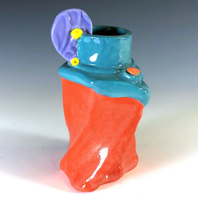 Spunky orange vase with a purple coin