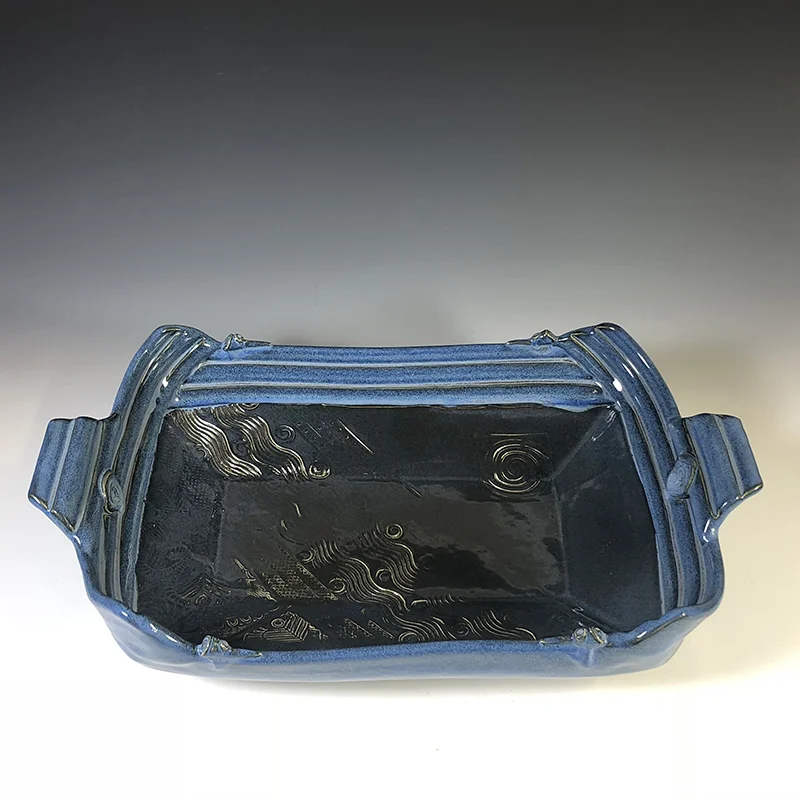 Mid-night and arctic blues enrich this footed serving platter