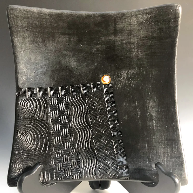 Less is more on this very contemporary black platter -- artfully functional