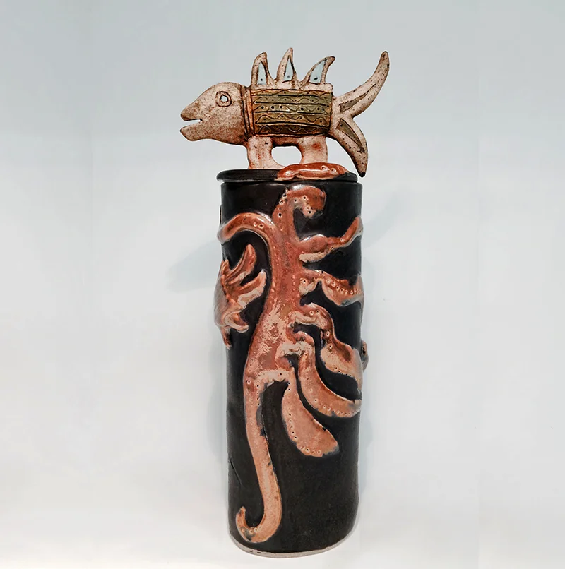 Friendly fish swims above seaweed on this treasure container