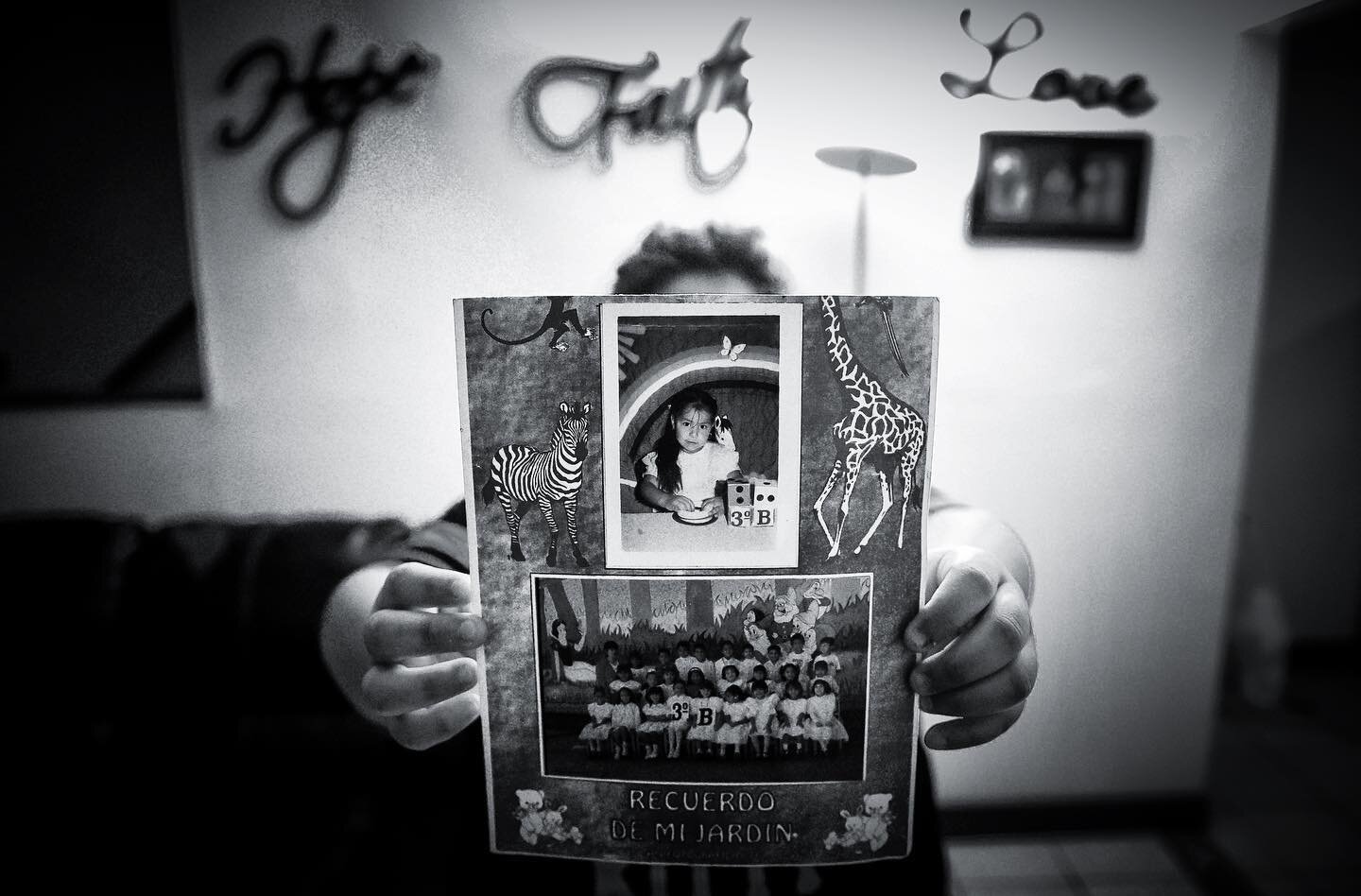 Jessica holds up an image of herself taken when she was in kindergarten back in Mexico, not long before she was brought to the United States by her mother. Jessica, now 29, has lived in the United States for just over 2 decades undocumented, after ar