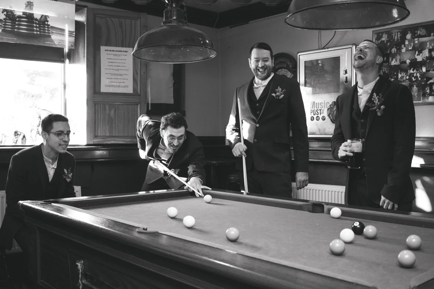 Groomsmen having a pint 