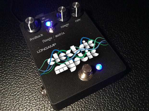 A guitar effects pedal labeled 'Electric Mystic' with four control knobs, LED indicators, and a footswitch, placed on a textured black surface.