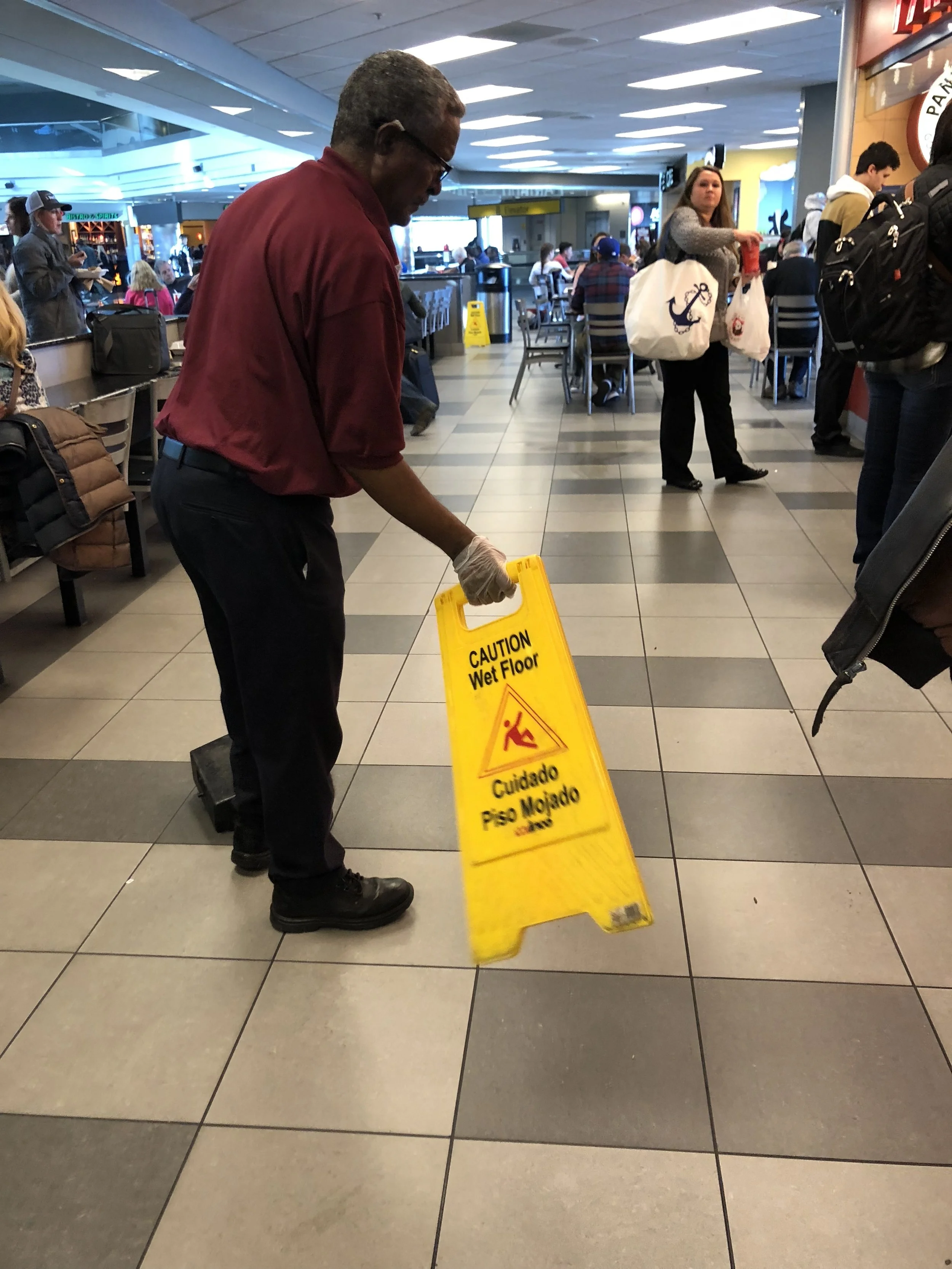 I saw this guy at the airport yesterday, waving the Wet Floor sign to dry the floor – I think these markers have reached their day.