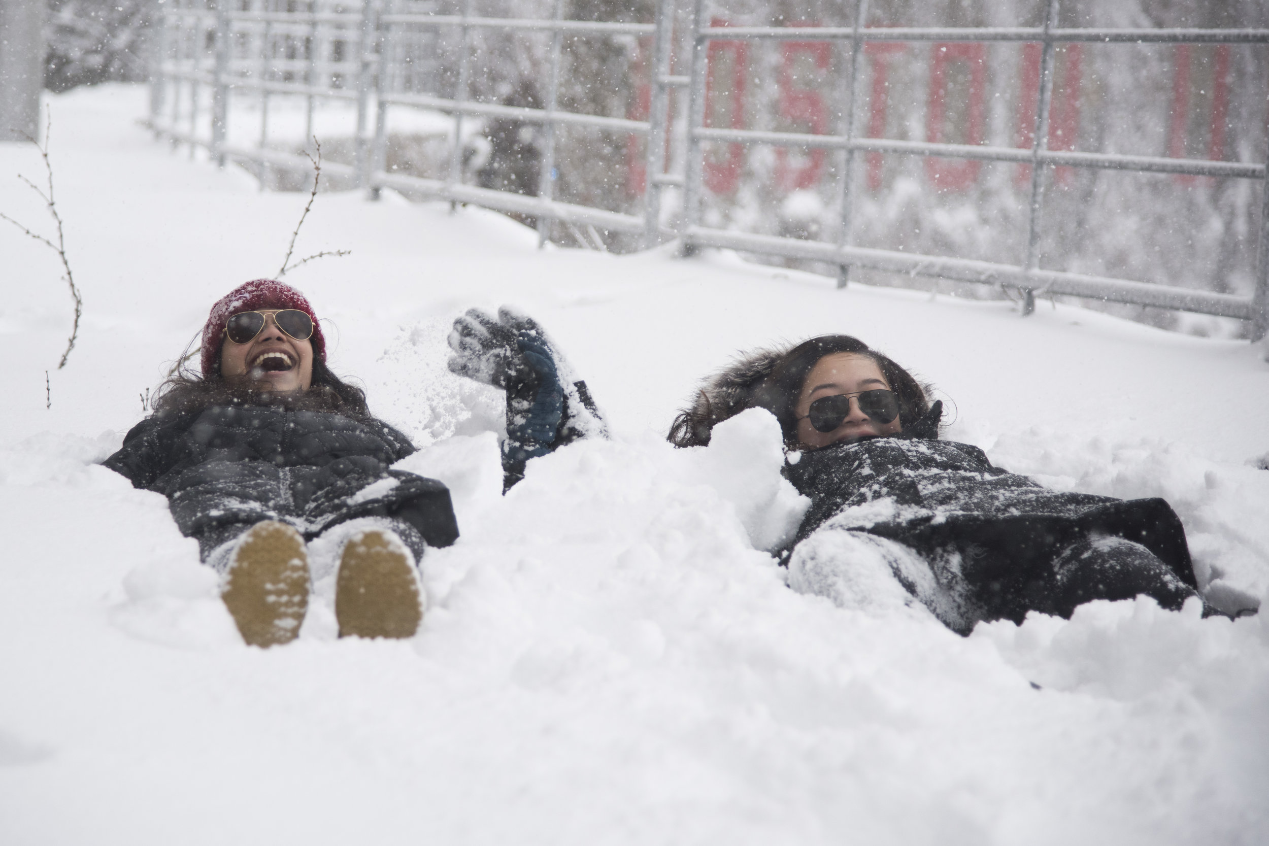  Sachi Mehrota and Tiffany Tong, both freshmen at Boston University, lay in the snow in BU's west campus during New England's third nor'easter in three weeks. The storm brought blizzard-like conditions and the cancellation of classes at BU, other loc