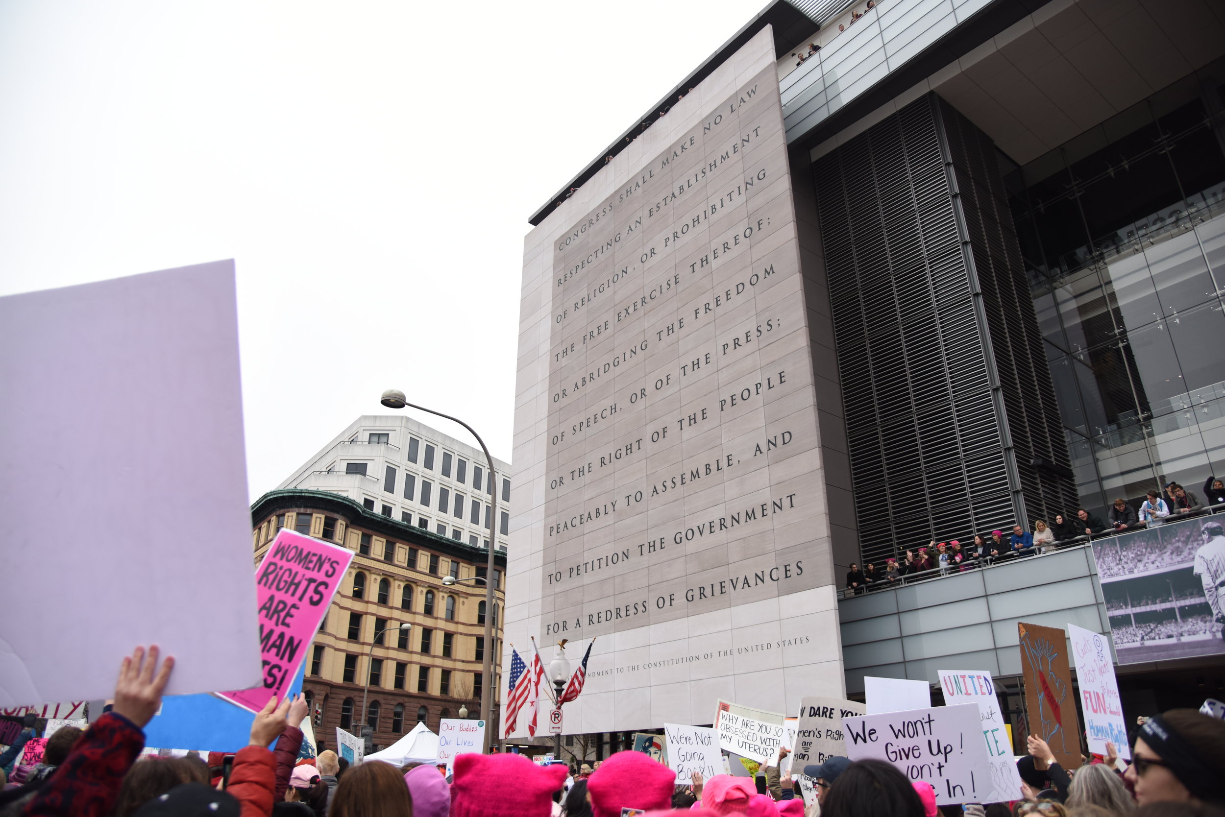  Marchers walk past the Newseum, the museum of news, in Washington D.C. during the Women's March on Washington, January 21 2017. Carved on the front of the museum is the first amendment to the constitution. 