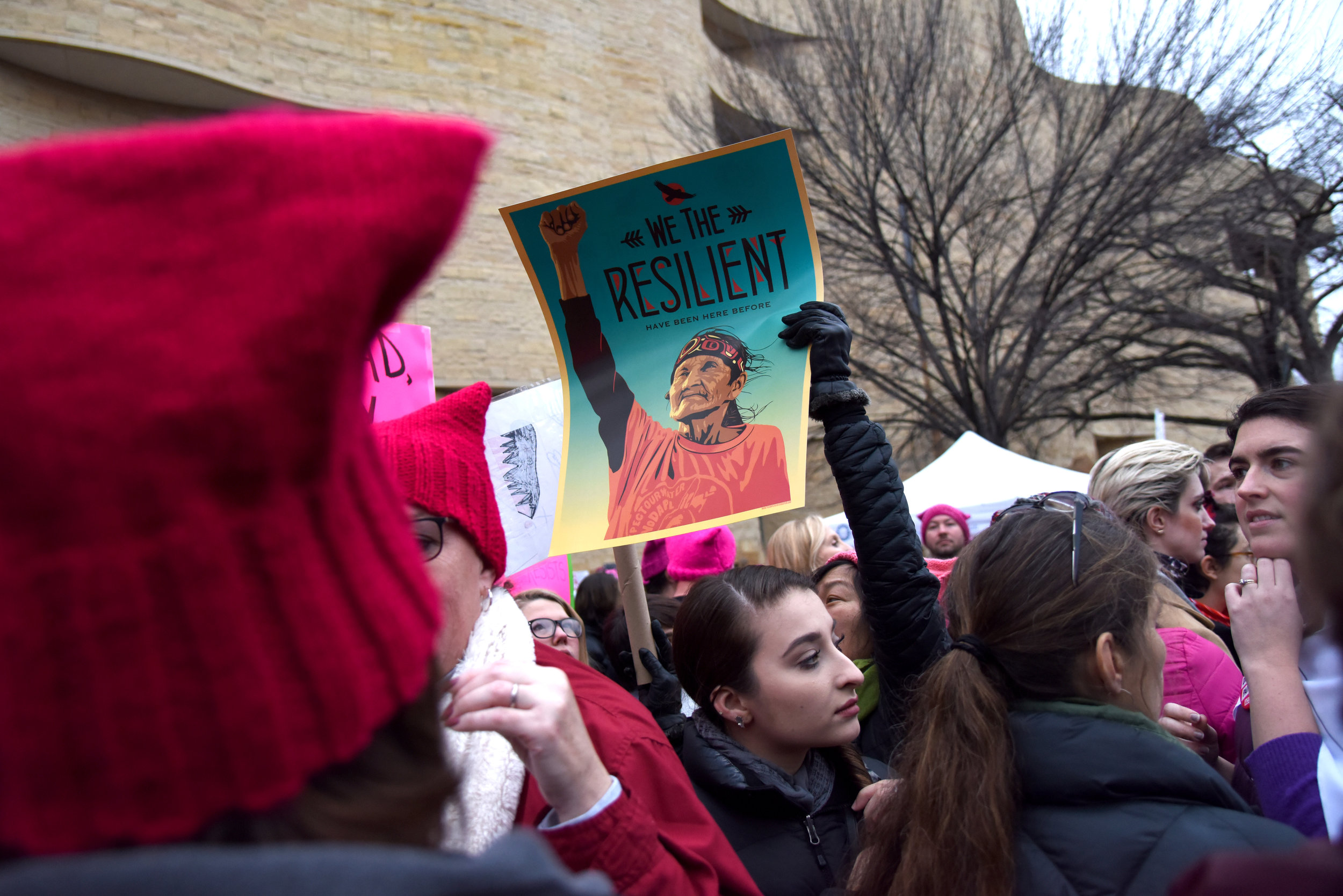  A marcher holds up a poster - designed by artist Shepard Fairey as part of a series for the Women's March - in front of the Museum of the American Indian during the Women's March on Washington in Washington D.C. January 21, 2017. 