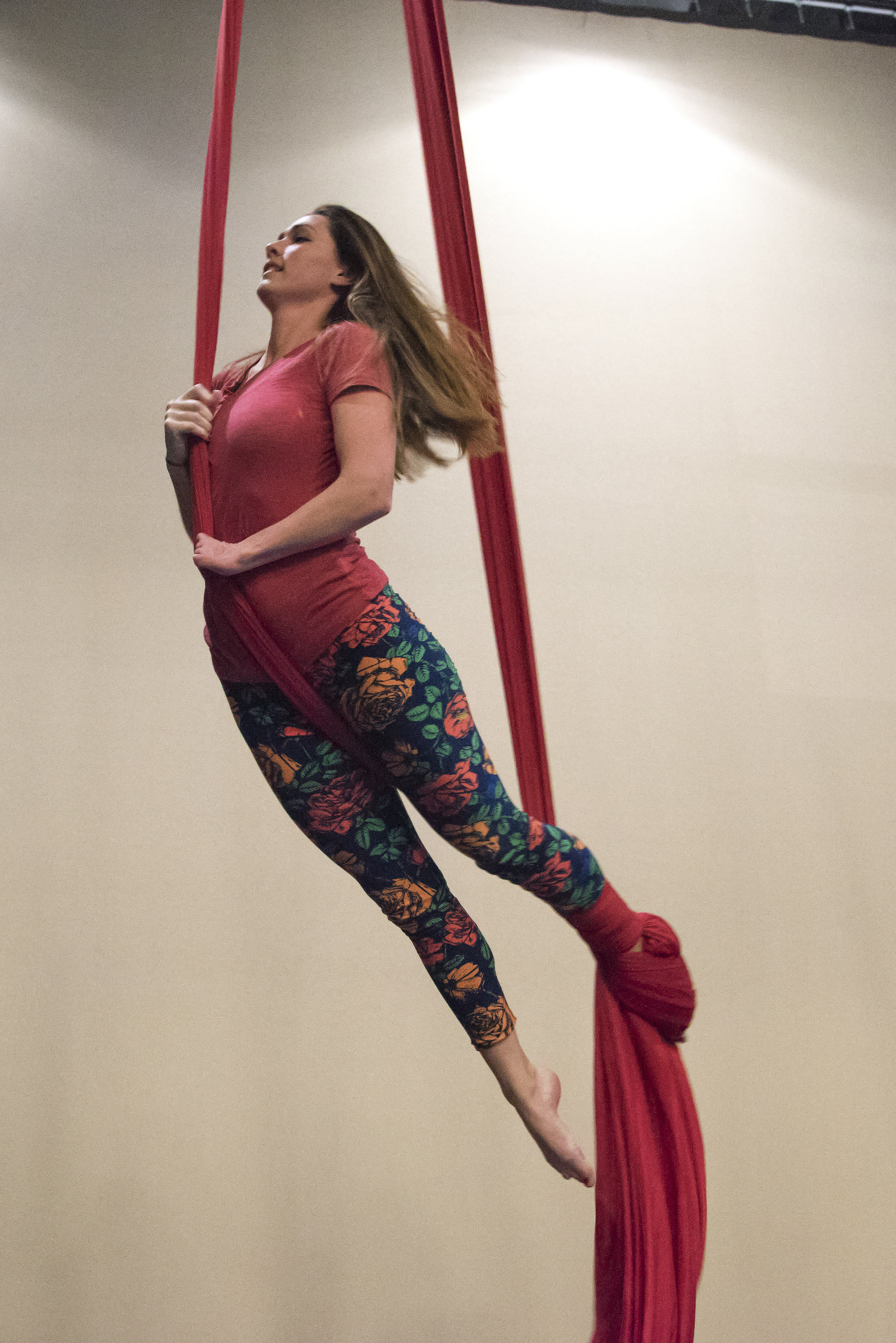  Suspended three feet in the air, Tuberty performs a peppermint wrap, one of the first silks moves students learn in a beginner aerial class. Tuberty must find new and different ways to approach aerial moves in order to accommodate the limited use of