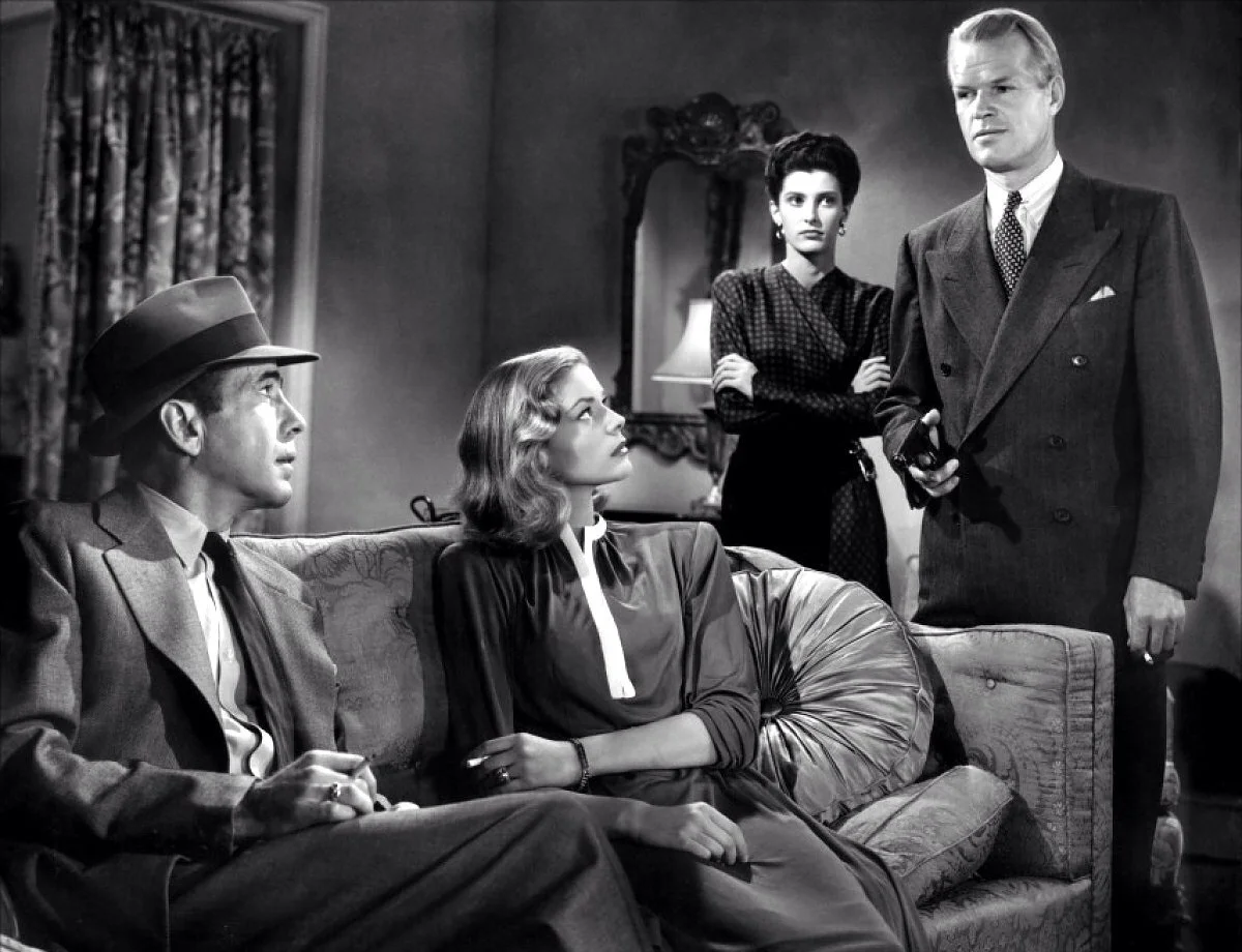 “She tried to sit on my lap while I was standing up,” Philip Marlowe. A quote from The Big Sleep. Foto credit: Warner Home Video