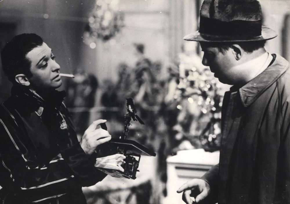 A scene between Octave (Jean Renoir), and Marquis Robert de la Cheyniest (Marcel Dalio) Retrieved from: https://www.imdb.com/title/tt0031885/mediaviewer/rm2424665600 .