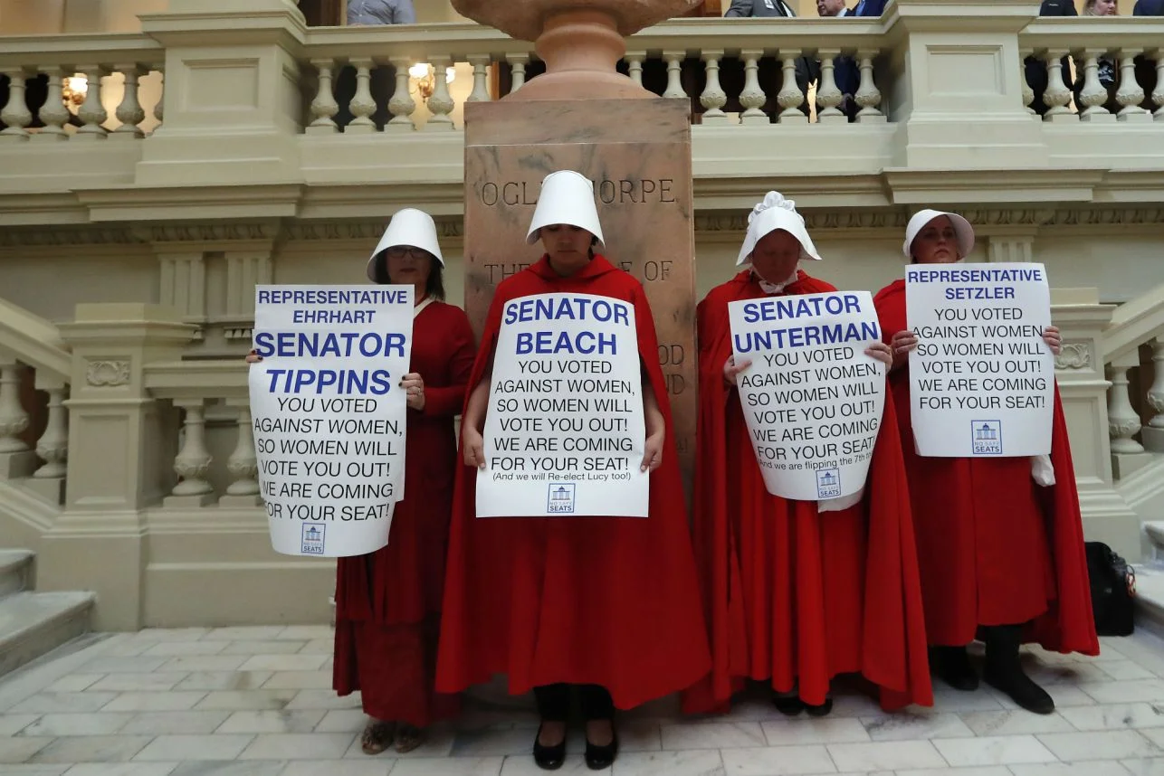 Women hold signs to protest HB 481 at the state Capitol on April 2 in Atlanta. Credit: AP. URL address: https://nypost.com/2019/04/03/alabama-anti-abortion-bill-likens-legalized-abortion-to-the-holocaust/