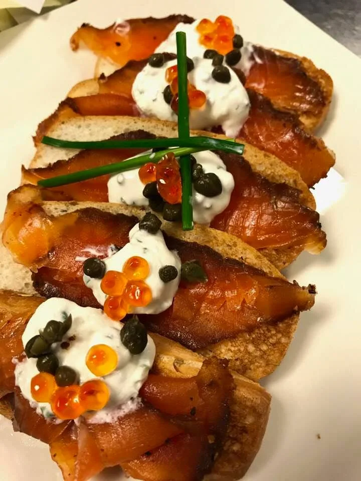 House cured pastrami salmon with chive creme fraiche, capers and salmon roe