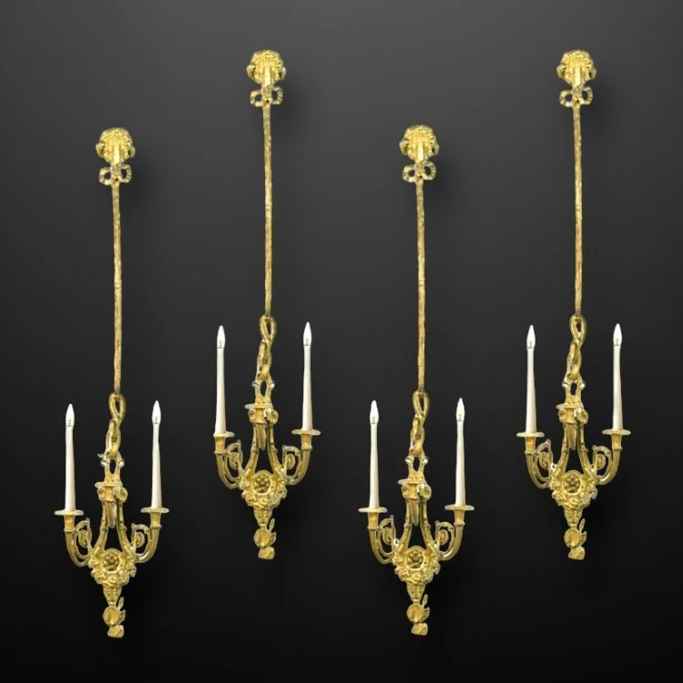 A set of four French Neoclassical gilt bronze wall-lights