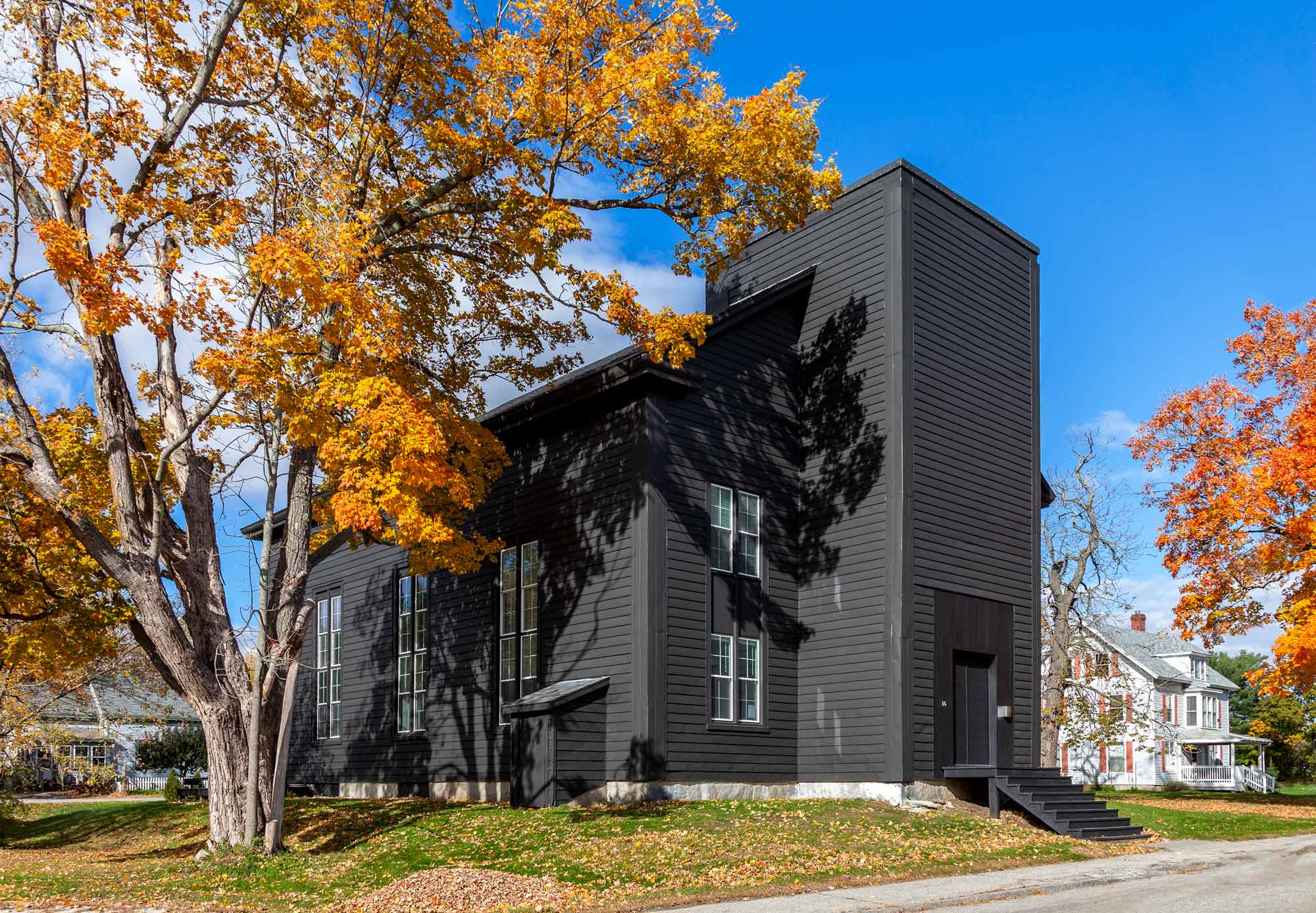 The exterior of the church, once white, McNeil had painted black, inspired by the look of Japanese fermented soot paint.