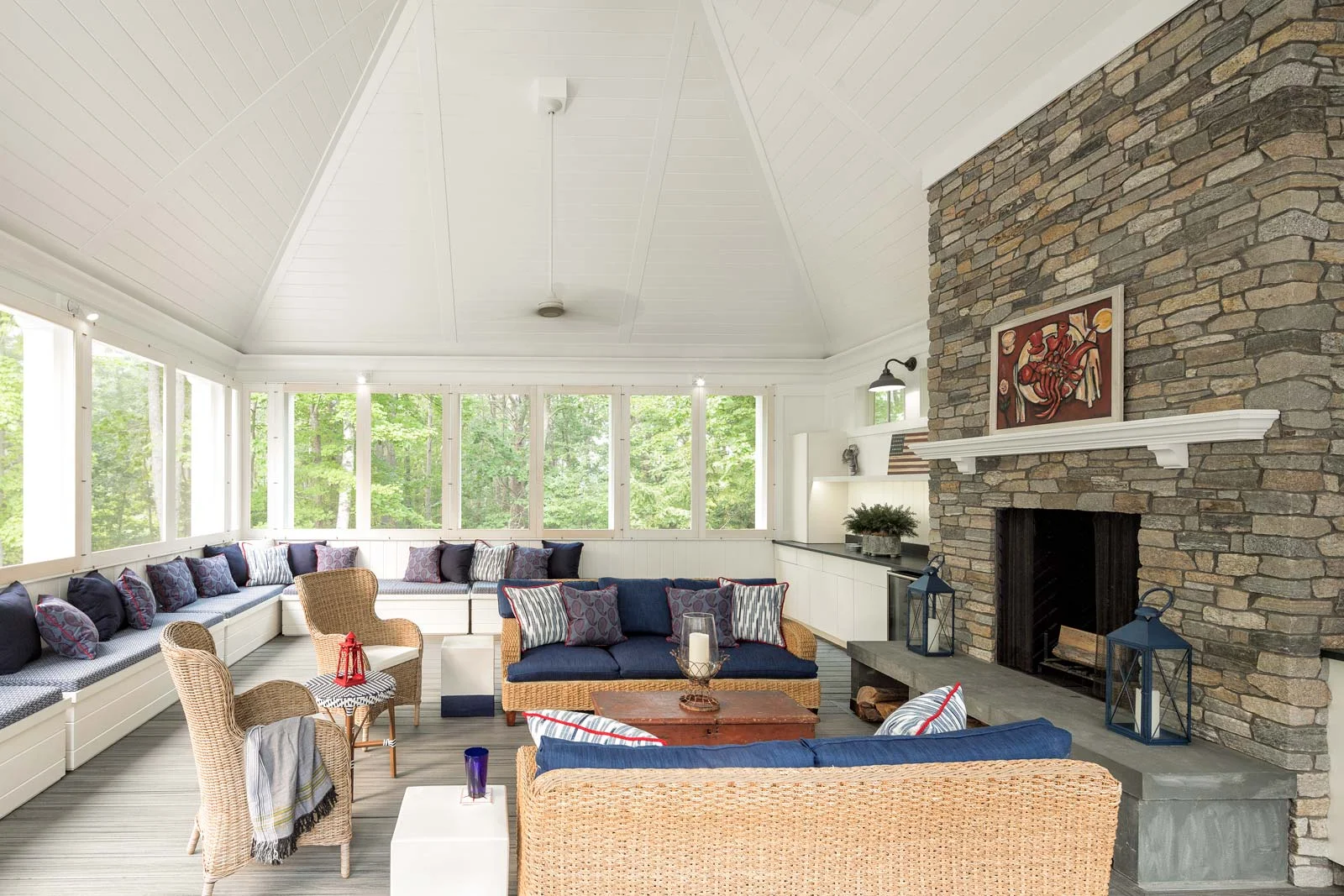 “We wanted to take advantage of the outdoor space,” says one of the homeowners of this screen porch that sits atop the garage and links back to a deck outside the kitchen through a catwalk.