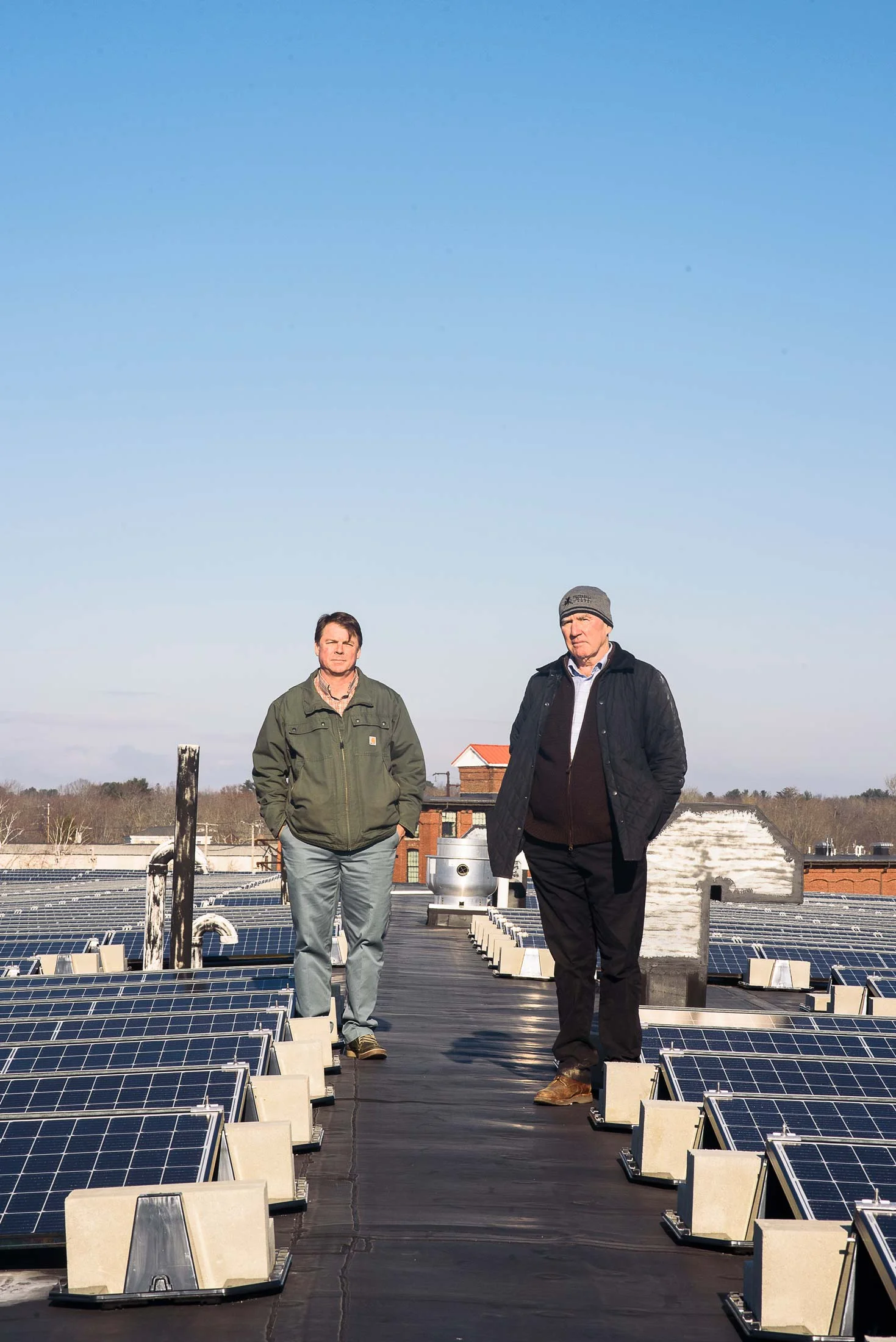 COO Scott Joslin (left), and CEO Doug Sanford (right), beside the solar array. Johanna Sorrell, of ReVision Energy, calls the pair “visionary.”