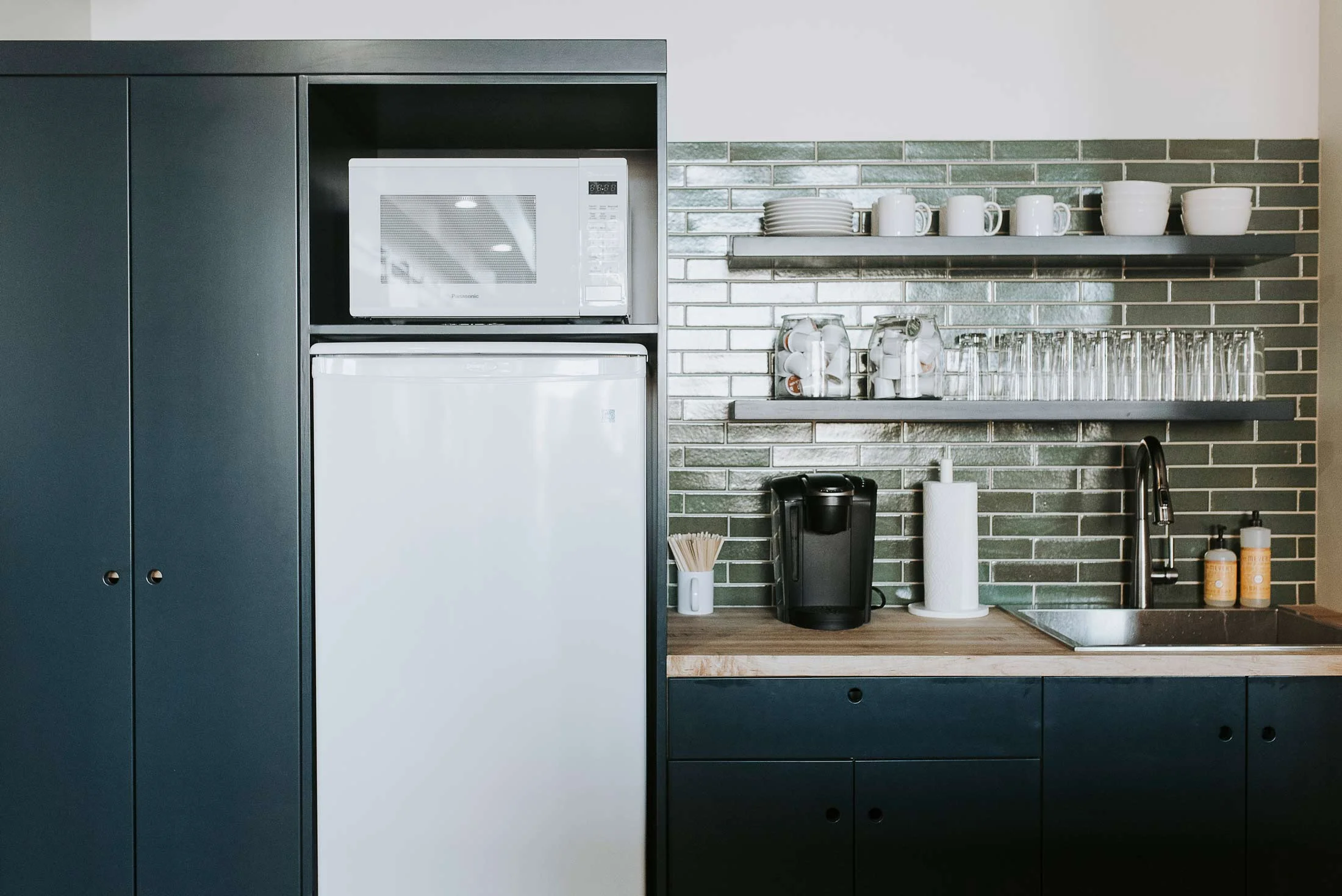 The communal kitchen is stocked with coffee and tea and offers a spot for refreshment and conversation.