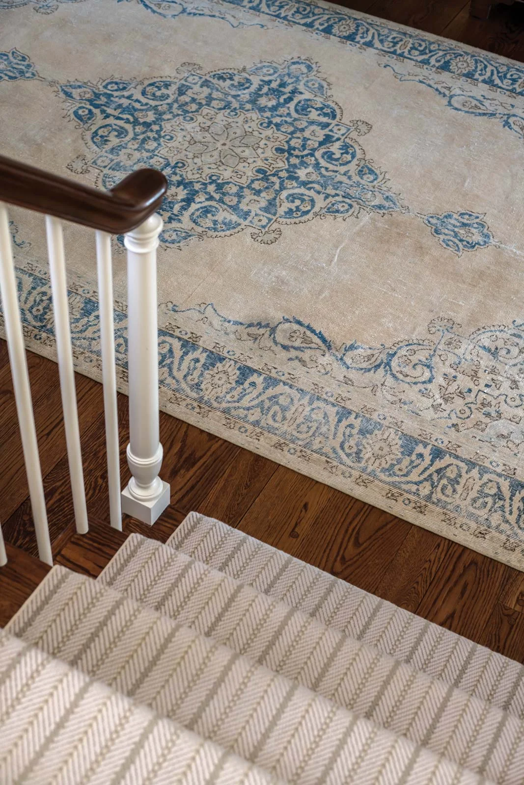 At the foot of the stairs, a vintage washed Persian rug from Simply Home.